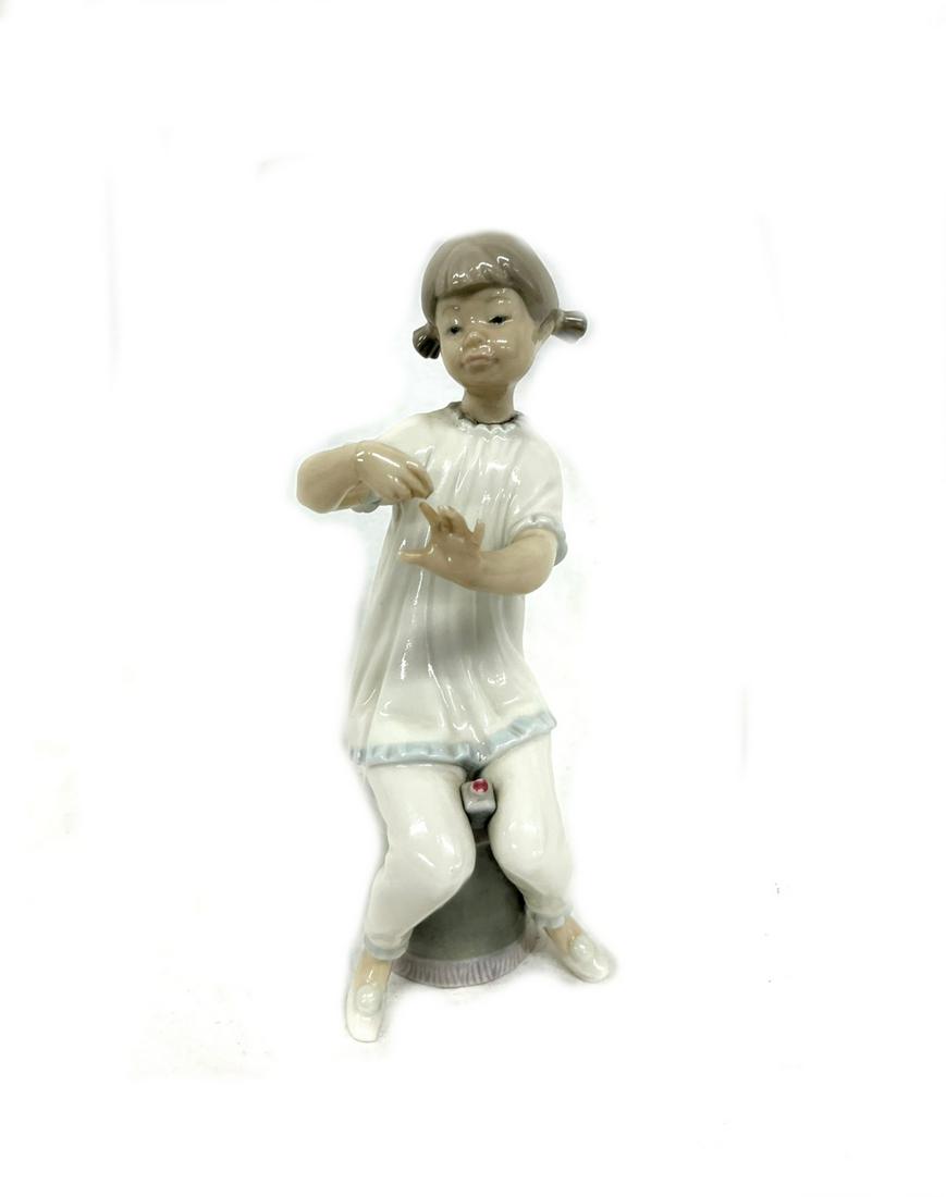 LLARDO Figurine Girl Sitting on Garden Stool: LLARDO Glossy Sculpture of Little Girl Manicuring Nails in Pajamas on a Chinese ? Garden Seat ? # 1082 Measuring 7" tall in Good Overall Condition Out of New York City Estate