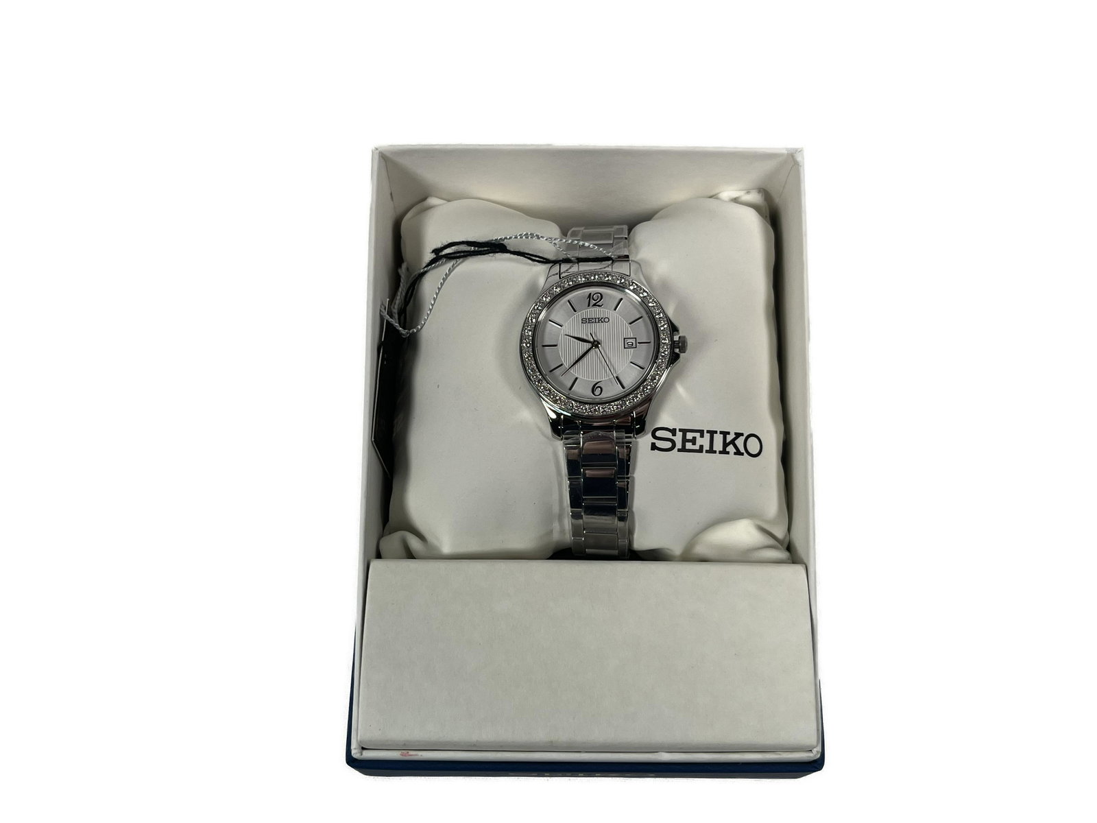 Seiko Watch: Seiko Watch with Swarovski Crystals Silver Dial Stainless Steel Watch 30mm wide and 6mm thick solid stainless steel case with crystals accented fixed bezel and textured push-pull crown textured milky 