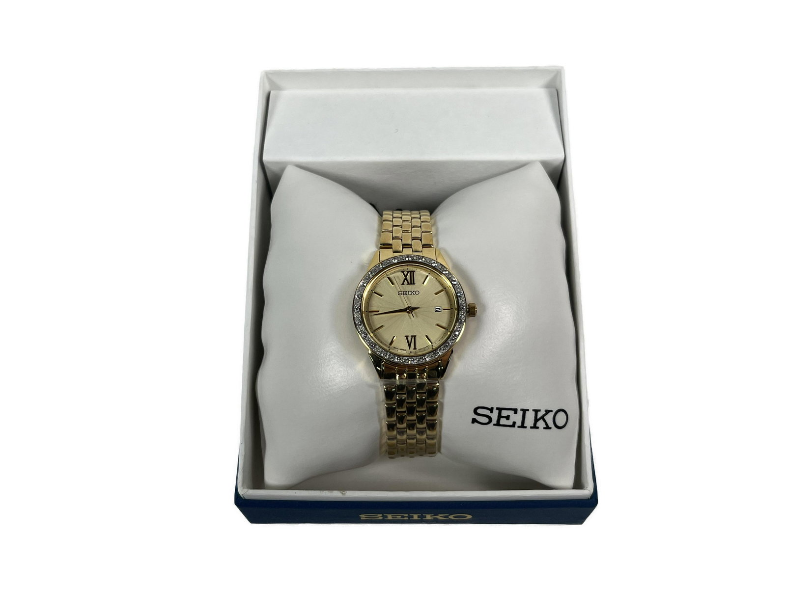 Seiko Watch: Seiko Watch Diamond Accent Gold/White Dial, Analog Display, Date Display, Swarovski Crystals on Bezel, Pull/Push Crown, Deployment Clasp Gold Tone Stainless Steel Case Gold Tone Stainless Steel Bracel