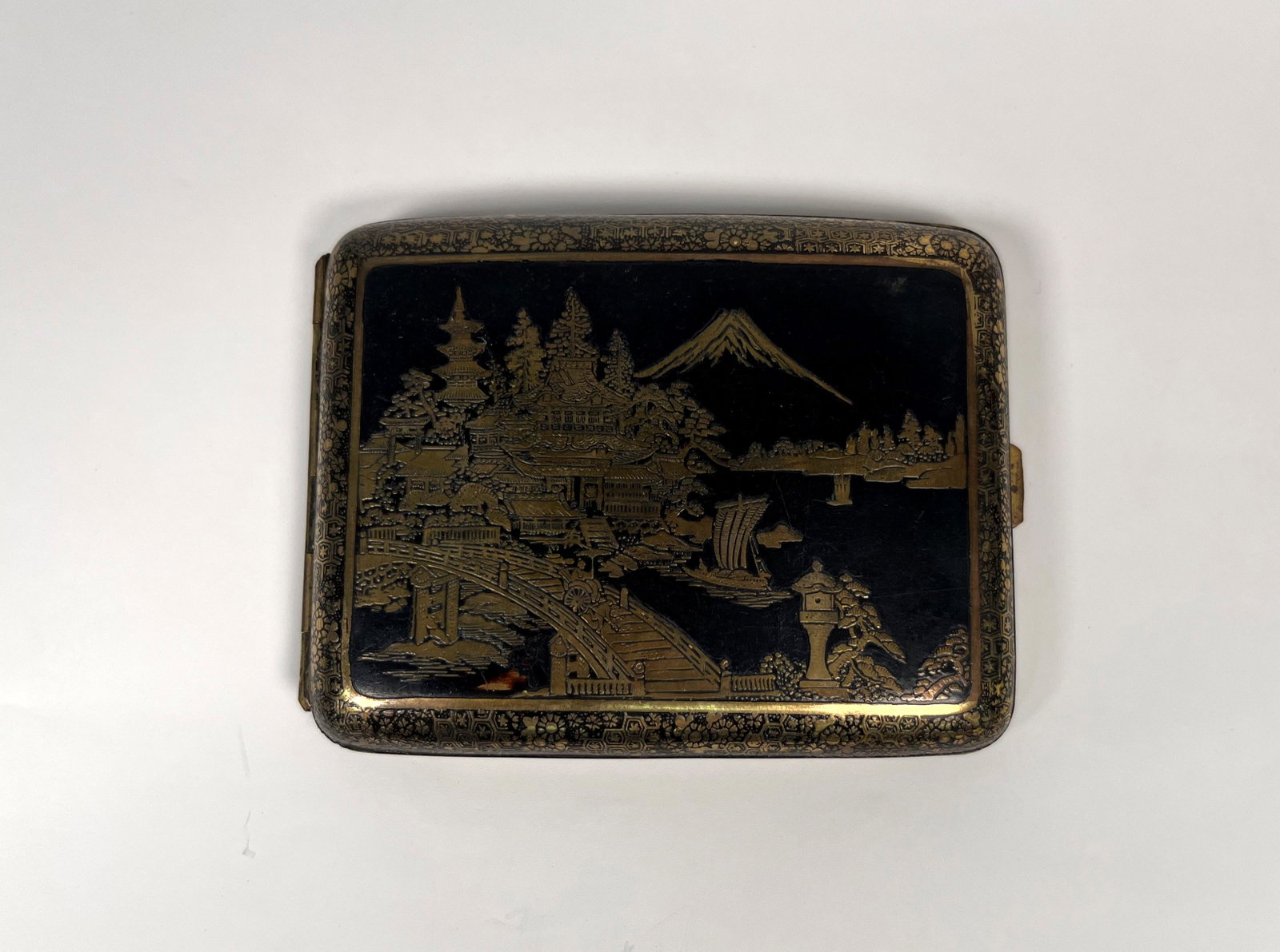 Japanese Gilt Damaszene Cigarette Case: Japanese Gilt Niello Damascus ? Cigarette Case Engraved with Pagodas & Mountain Landscape possibly 24k gold inlaid 4.25" L x 3.25" W Minor Wear Condition consistent with age Please look Photos Closely