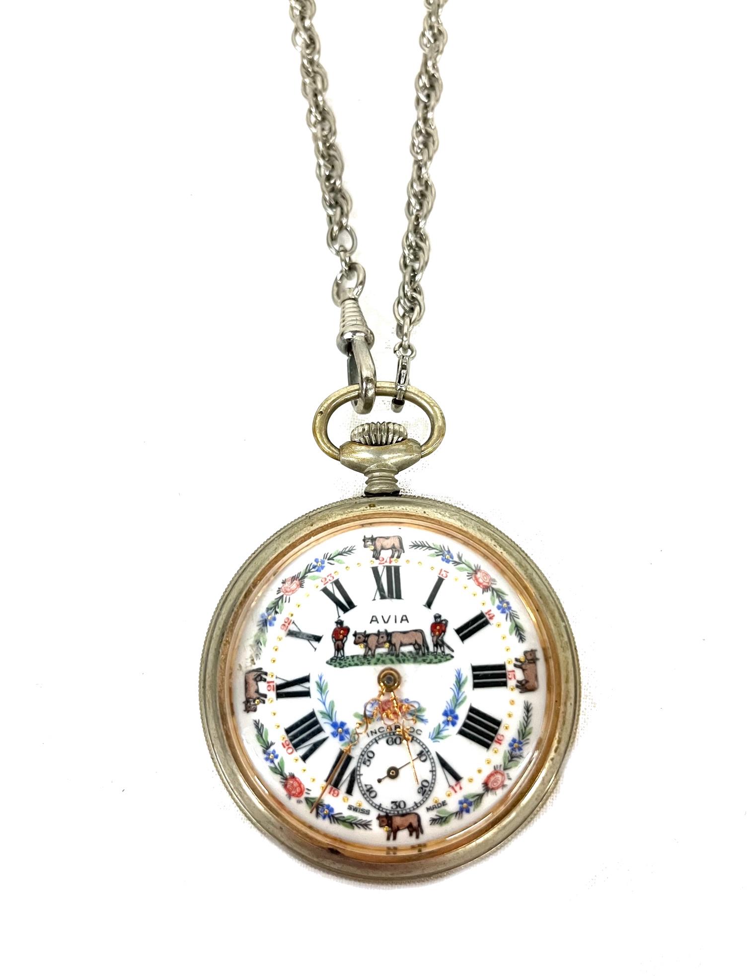 Enameled Open Face Pocket Watch: Enamled Open Face Wind Up Jewels Pocket Watch with Cow and Farmer Engraving on Back and Roman Numeral Dial Comes with Chain Watch Fob Measures 2" D avia swiss Please refer to photos Out of New York Ci