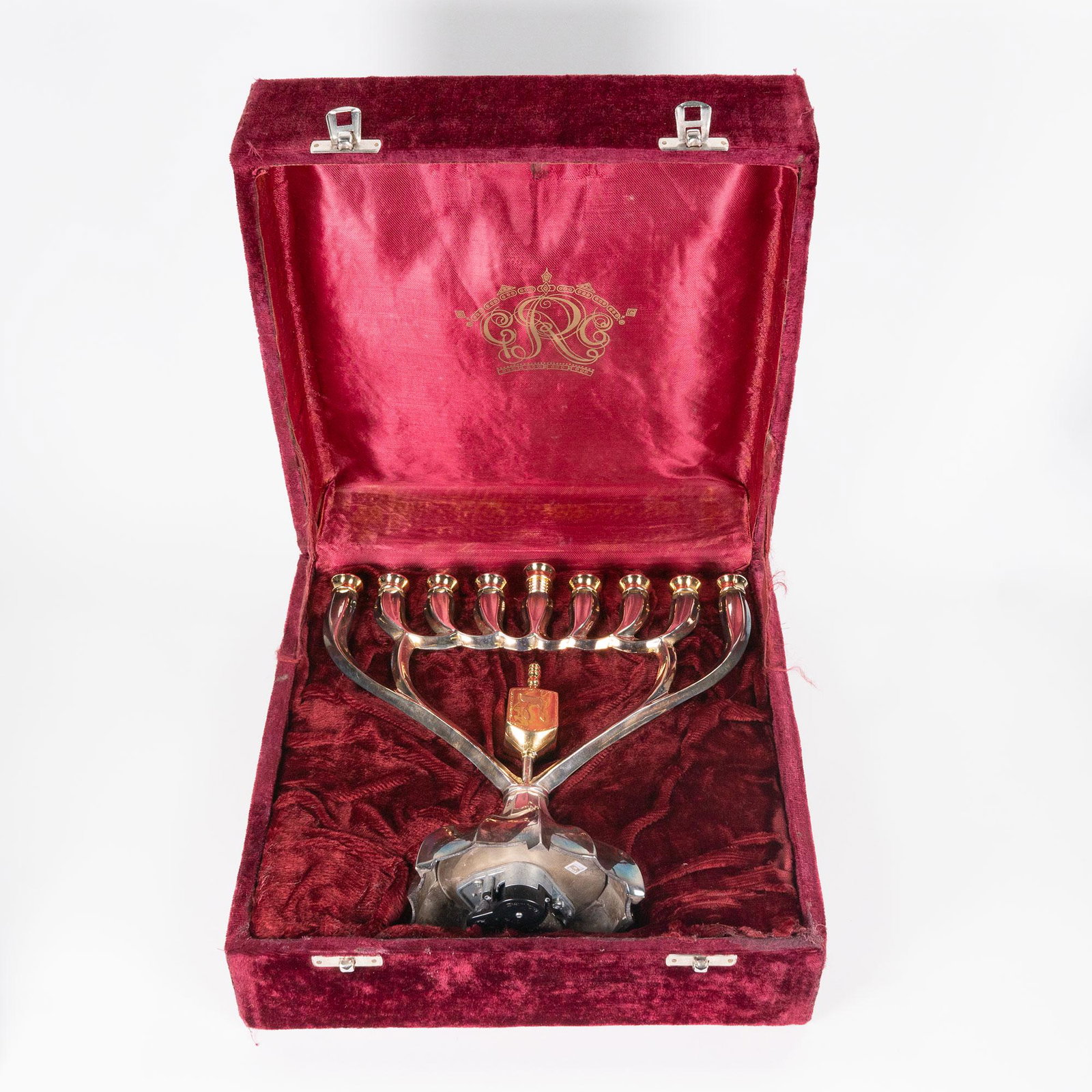 Judaica Menorah Hanukkah Lot: Judaica Music Box Menorah Hanukah and Three other Menorahs Include: 1.Menorah with music box in it's base in a Red Velvet Box Dimensions: 9" H 9.5" L Base - 5" Marked Underneath Made in India 2. Metal