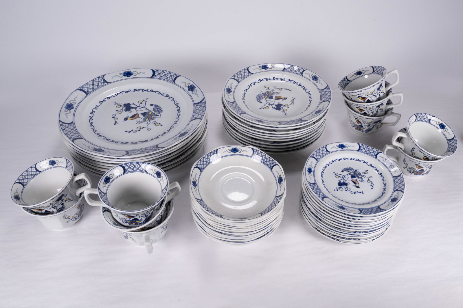 Wedgwood Volendan Dinnerware Porcelain 52Pcs: Wedgewood Porcelain Dinnerware Hand Painted in the 'Volendam' Pattern Featuring a Bird and Floral Motif Each Piece is Stamped Underneath "Wedgwood Volendam Georgetown Collection Made In England" Lot I