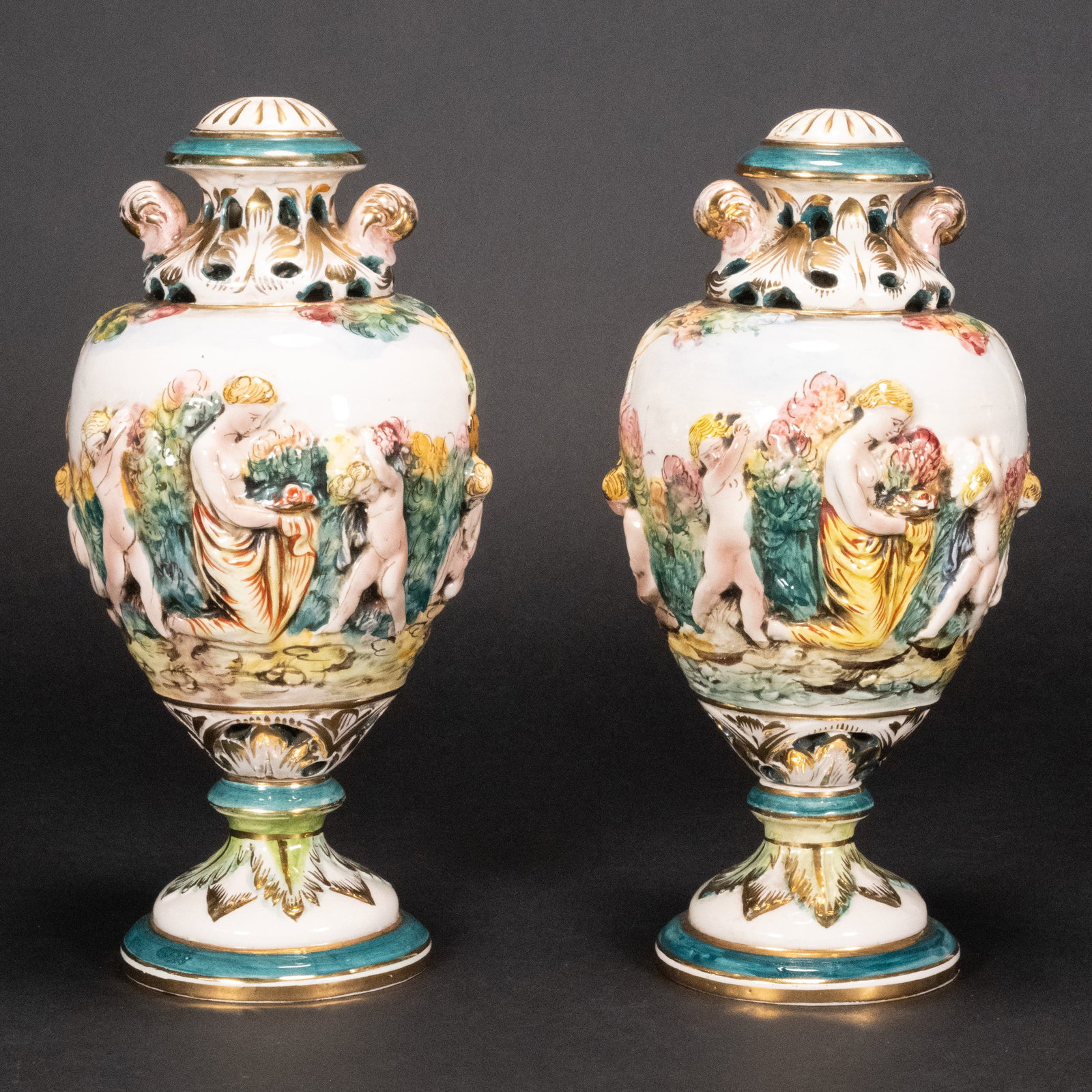 Capodimonte Porcelain Vase Pair: Pair of Italian Capodimonte Porcelain Covered Vases Hand Painted Polychrome with Gold Gilt Rising on a Pedestal Foot Decorated Figural Landscape Scene with Allegorical Figures Art Nouveau Floral Motif