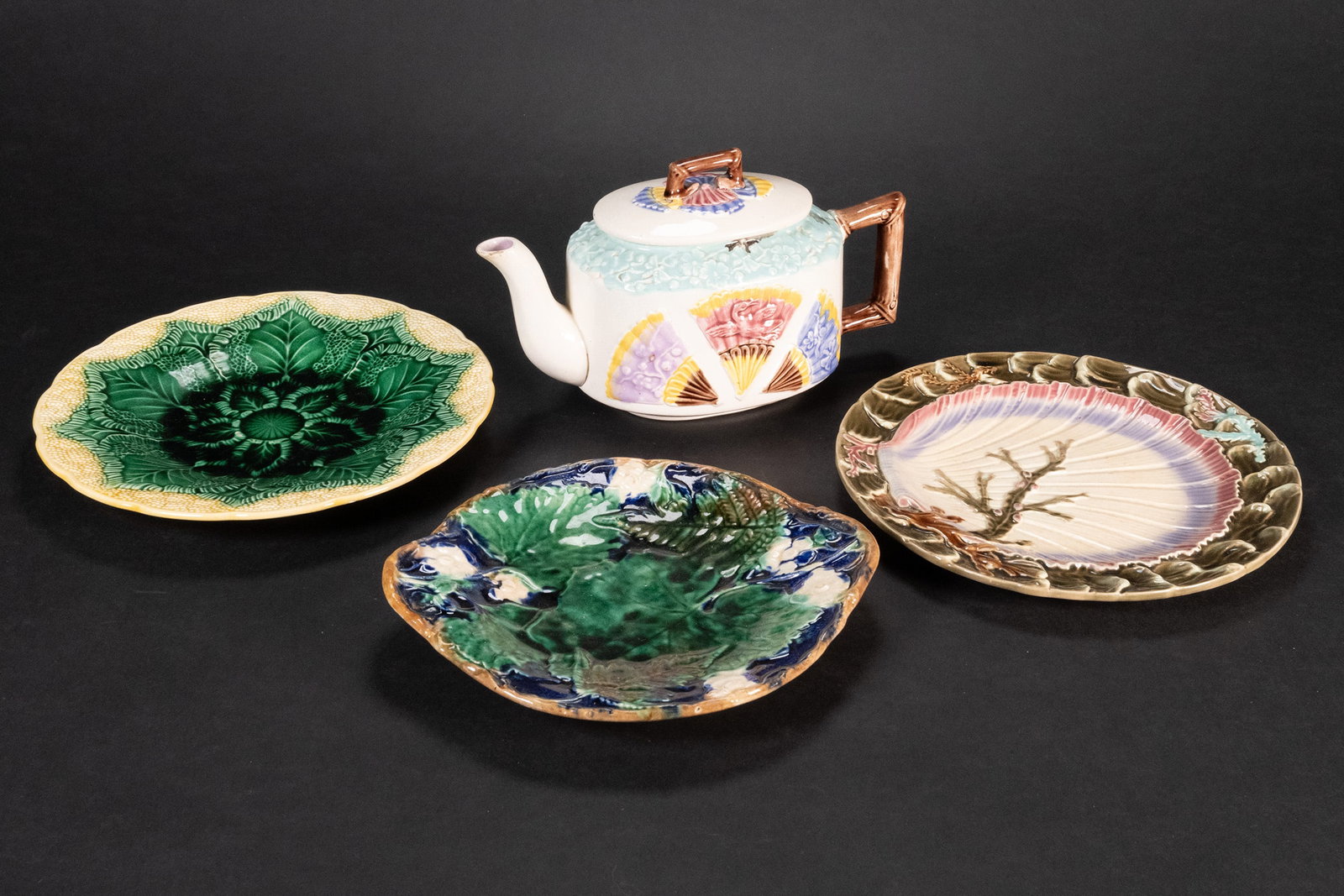 Majolica Earthen Ware Lot Wedgwood: Majolica Ceramic Wares Grouping Lot Teapot Plates Aesthetic Movement Majolica Fan Cranes Butterflies Teapot circa 1885 Creamy White Background With Embossed Fans Containing Crane or Butterfly 10" Spou