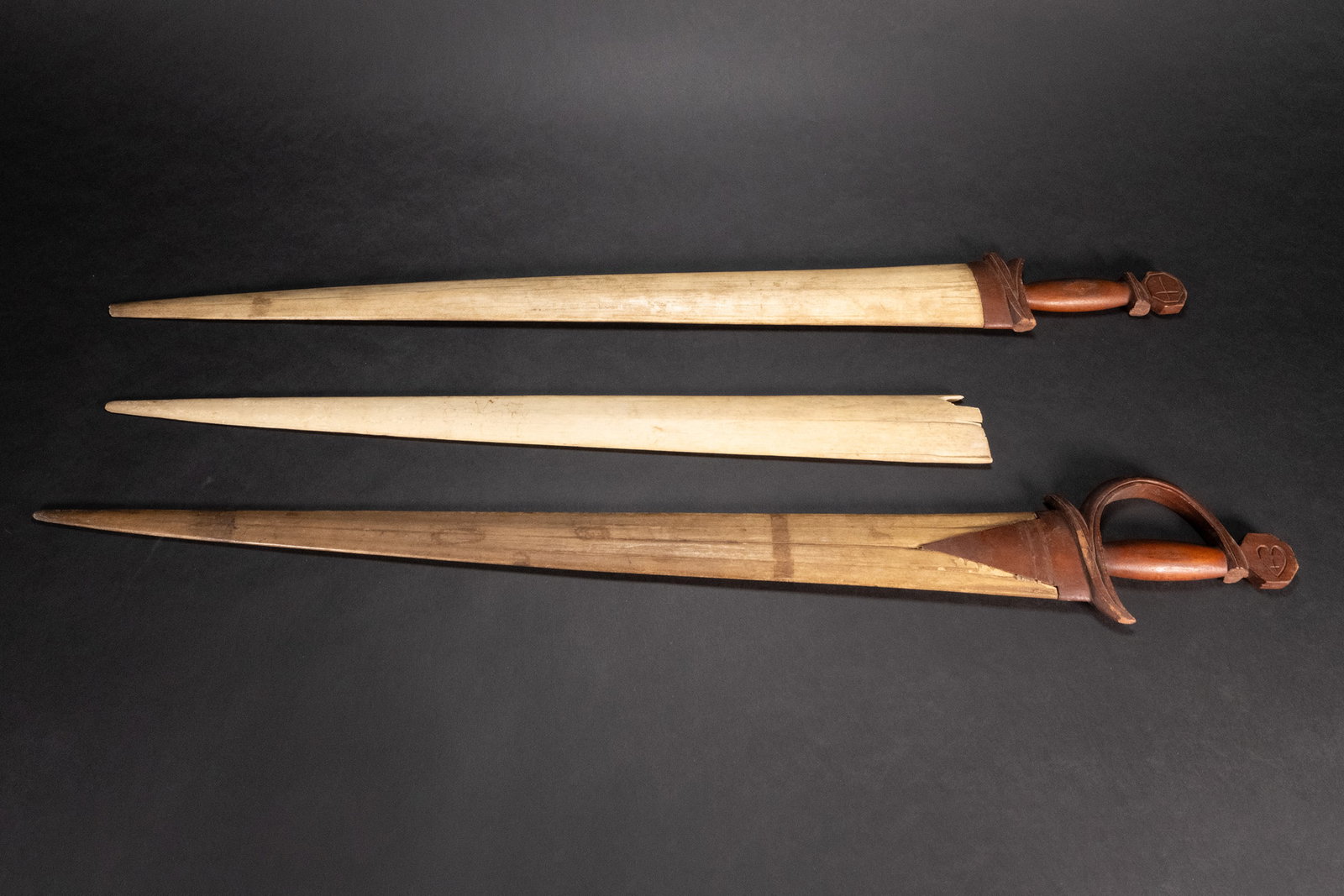 19th c. Whailing Scrimshaw Swordfish Sword Collection Lot: 19th / 20th Century Whaling Whale Bone Moustache Sword Fish Saber Collection Lot #1 38" In Length Tip to Pommel 3" Widest Point Hand Carved Heart with Cross on One Side and bigger Cross on Other Hand