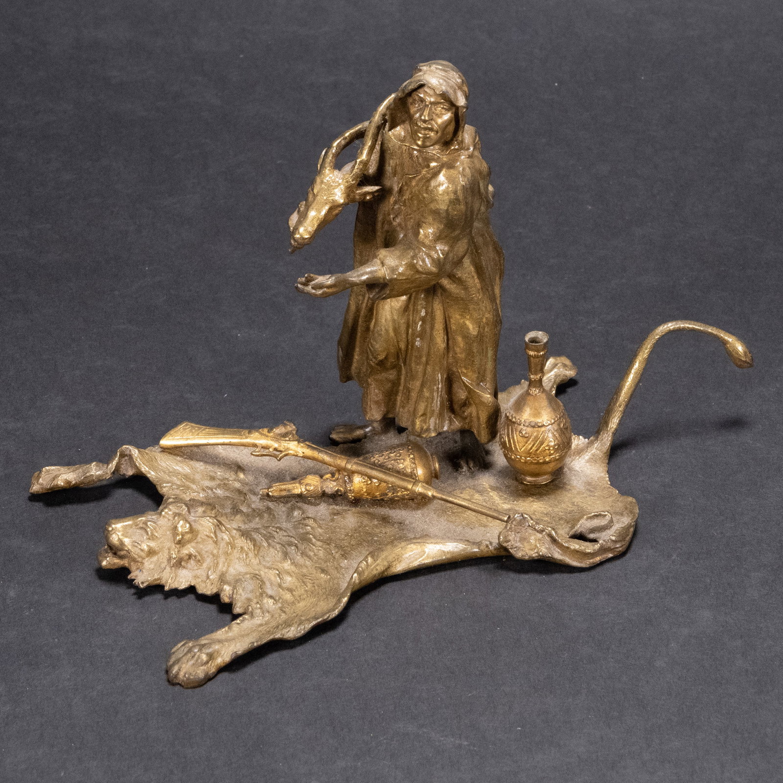 Franz Bergman (Vien Austria 1898-1963) Orientalist Bronze Sculpture: Franz Bergman ( Vienna Austria 1898 - 1963 ) Oriental Cold Painted Bronze Sculpture Depicting a Bedouin Trader Muslim Arab Man Salesman Holding an Ibex Head Standing on a Lion Skin Taxidermy Persian R