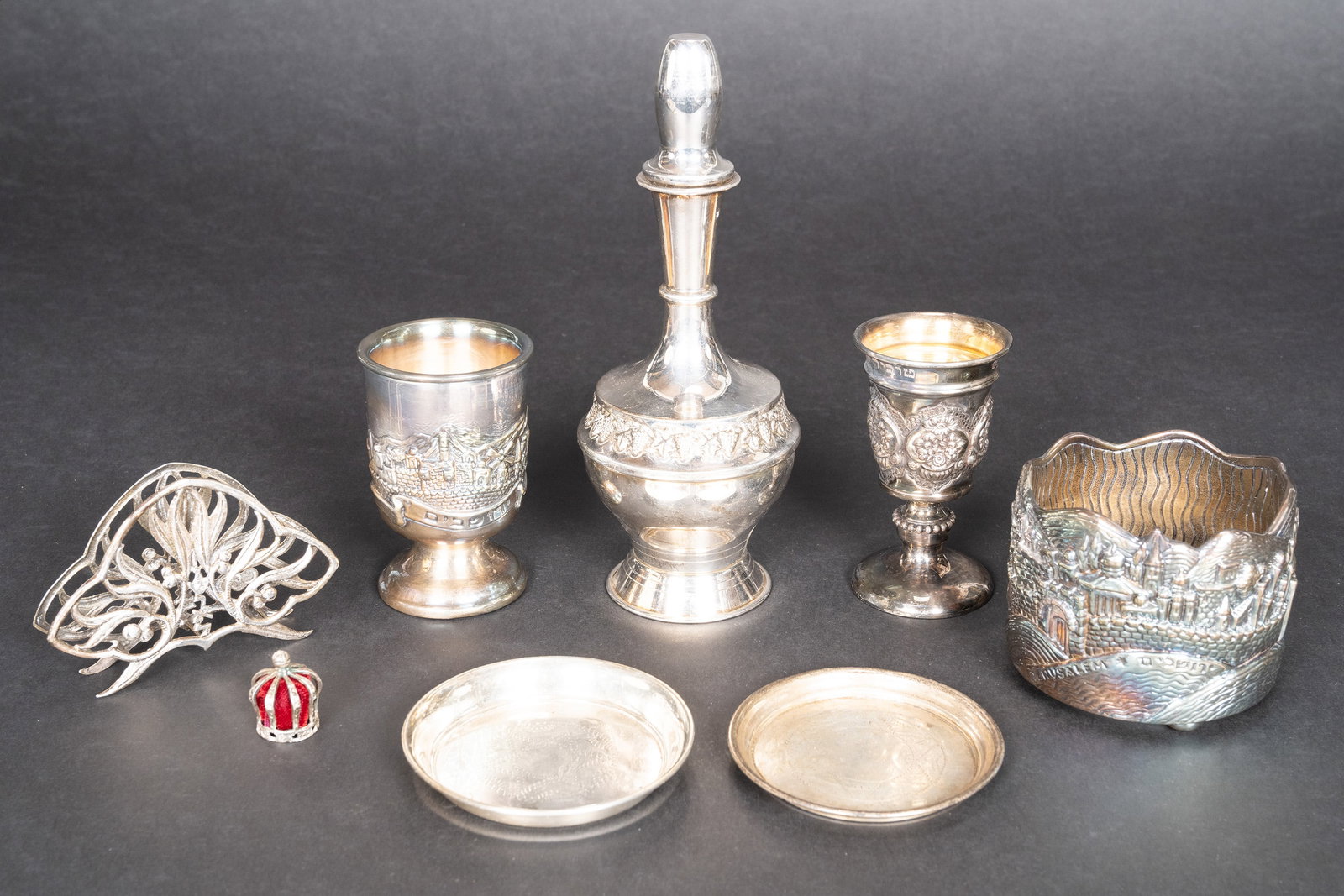 Judaica Sterling Silver Tableware Collection Group Lot: Judaic Sterling Silver Tableware Collection Grouping Lot Total Sterling Silver Weight: 632 Grams and 875 Silver Weight: 52.6 Grams Lot Comprising: 1x Sterling Crown Figurine with Red Velvet Fabric Ins