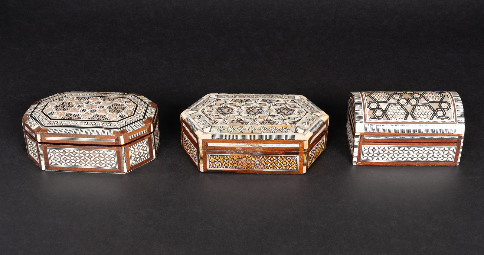 Moroccan Intarsia Mother of Pearl & Bone Inlaid Wood Vanity Box Collection Group Lot: Moroccan Intarsia Mother of Pearl & Bone Inlaid Wood Box Collection Grouping Lot Each with Intricate Geometric Inlay and Contrasting Wood Red velvet interior Lot Comprising: 1x Dome Shaped Box Approx: