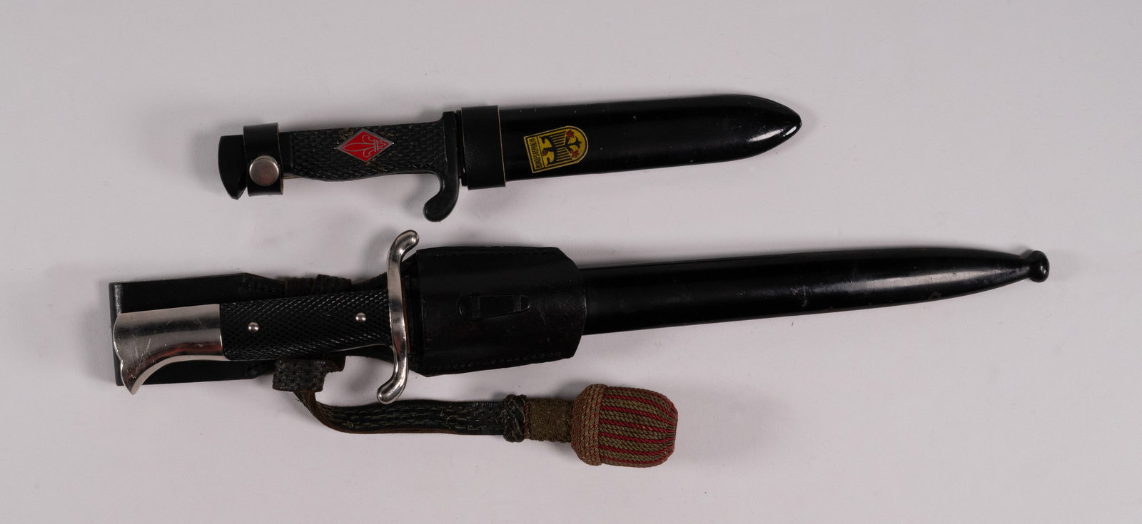 WWII German Fire Police Dress Bayonet & FES Boy Scout Knife: World War Two II WW2 German Fire-Police Dress Bayonet With Scabbard and FES German Post War Boy Scout Knife With Scabbard dagger black Bakelite grips with red diamond (Fleur di Lis) on one side blade