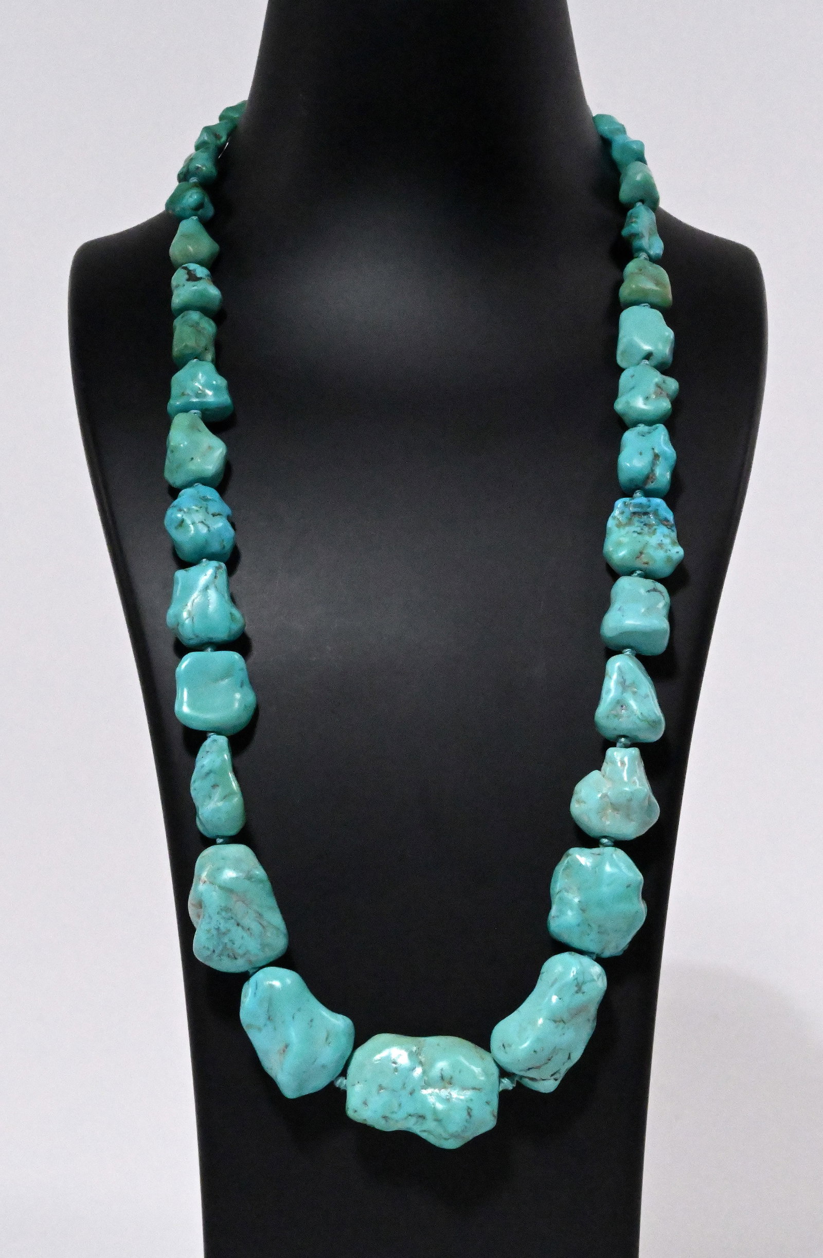 Navajo Native American Turquoise Graduated Knotted Necklace Sterling Silver Clasp: Navajo Tribe Native American Indian Turquoise Cabochon Graduated Knotted Necklace Sterling Silver Clasp Hallmark to Reverse of Slide Box Clasp Closure Box: "925" Approx: 24 1/4"L Turquoise Range: 1 1/