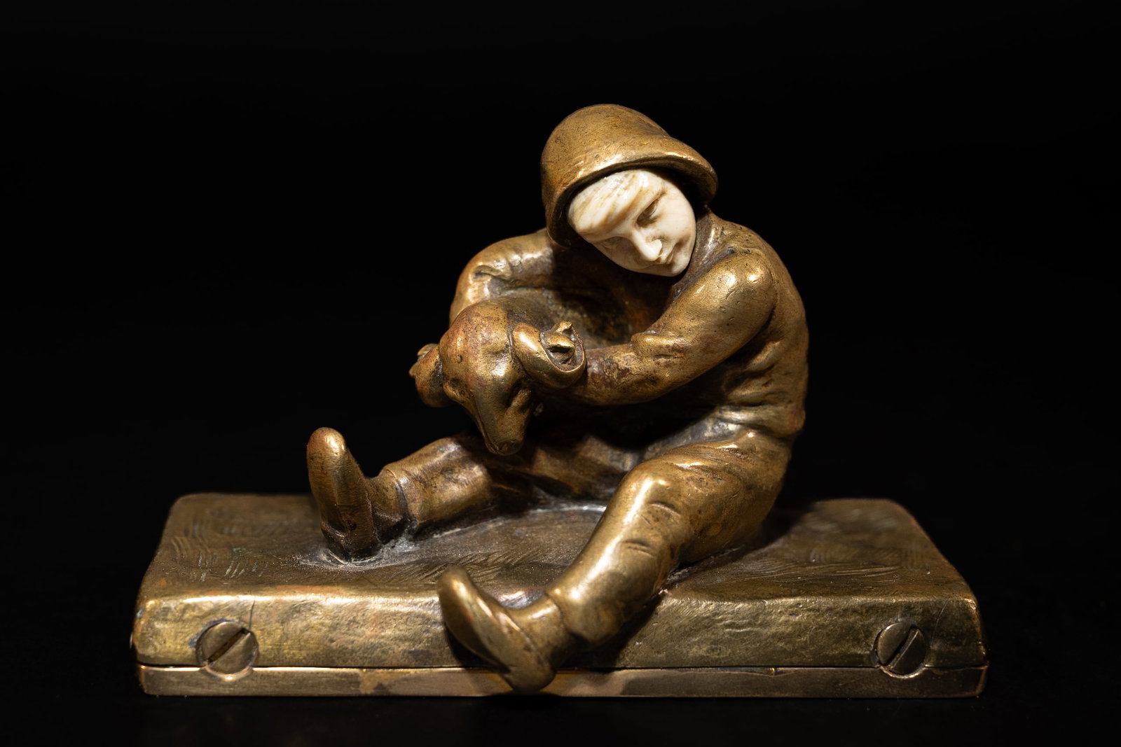 Peter Tereszcuk (Austria, 1875-1963) Gild Bronze & Bone Sculpture: Peter Tereszcuk ( Austrian 1875 - 1963 ) Gilt Bronze and Bone Figure Statue Depicting Sitting Peasant Shepherd Boy with Bone Face Holding Ram on Rectangular Plynth Signed to Reverse: " AR P. Tereszczu