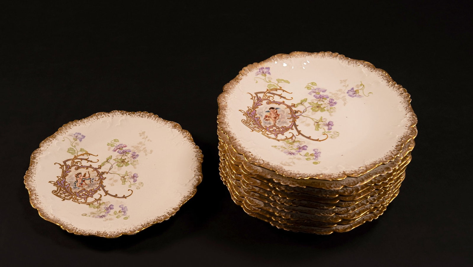 Lot of 10 Antique LaViolette Limoge 7.25" Plates Cherubs: Lot of 10 Antique LaViolette Limoge 7.25" Plates Cherubs Made by LaViolette of France (Makers Mark on Reverse) 1896 - 1905 Each Plate Hosts a Gold Gilded "Scalloped" Rim With an Image of a Cherub in t