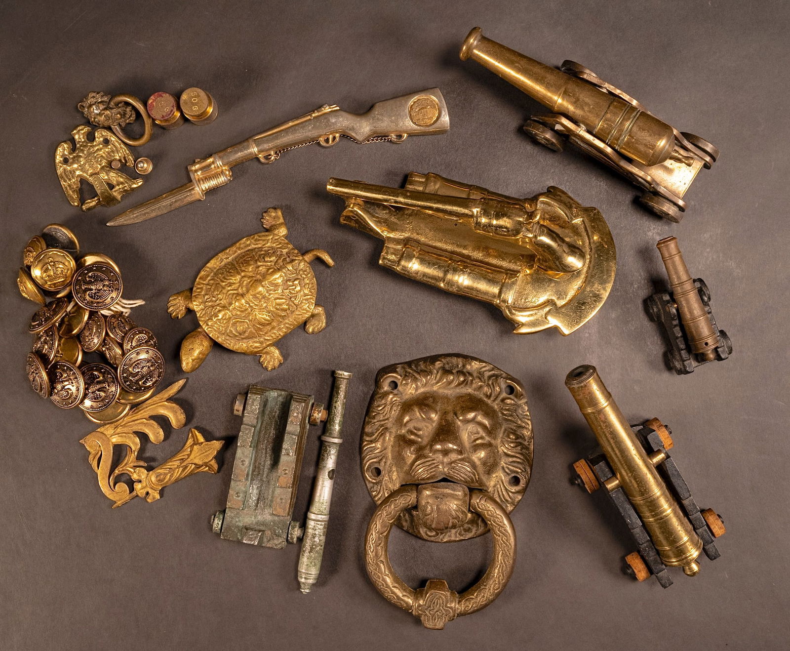 Bronze Door Knocker Cannon Trinket Box etc Collection: Brass Items Door Knocker Cannon Trinket Box Consisting Lions Head Door Knocker 6" x 3.5" Pistol Door Knocker 6.5" x 4" Hinged Turtle Trinket Box 4.5' X 3" Brass Cannon & Carriage 6" x 2" Brass Cannon