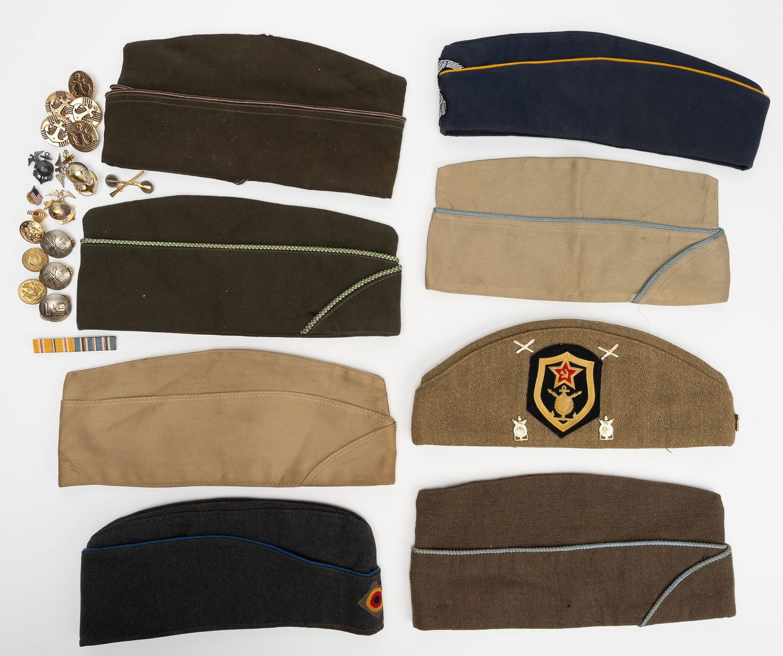 WWII Militaria Collection Field Side Cap Silver Insignia US German Russian etc: World War II Post War Period Representing Multiple Nations And Branches of Service Including 8 Military Field and Garrison Caps In Various Materials And Colors Featuring A World War II Era German Side