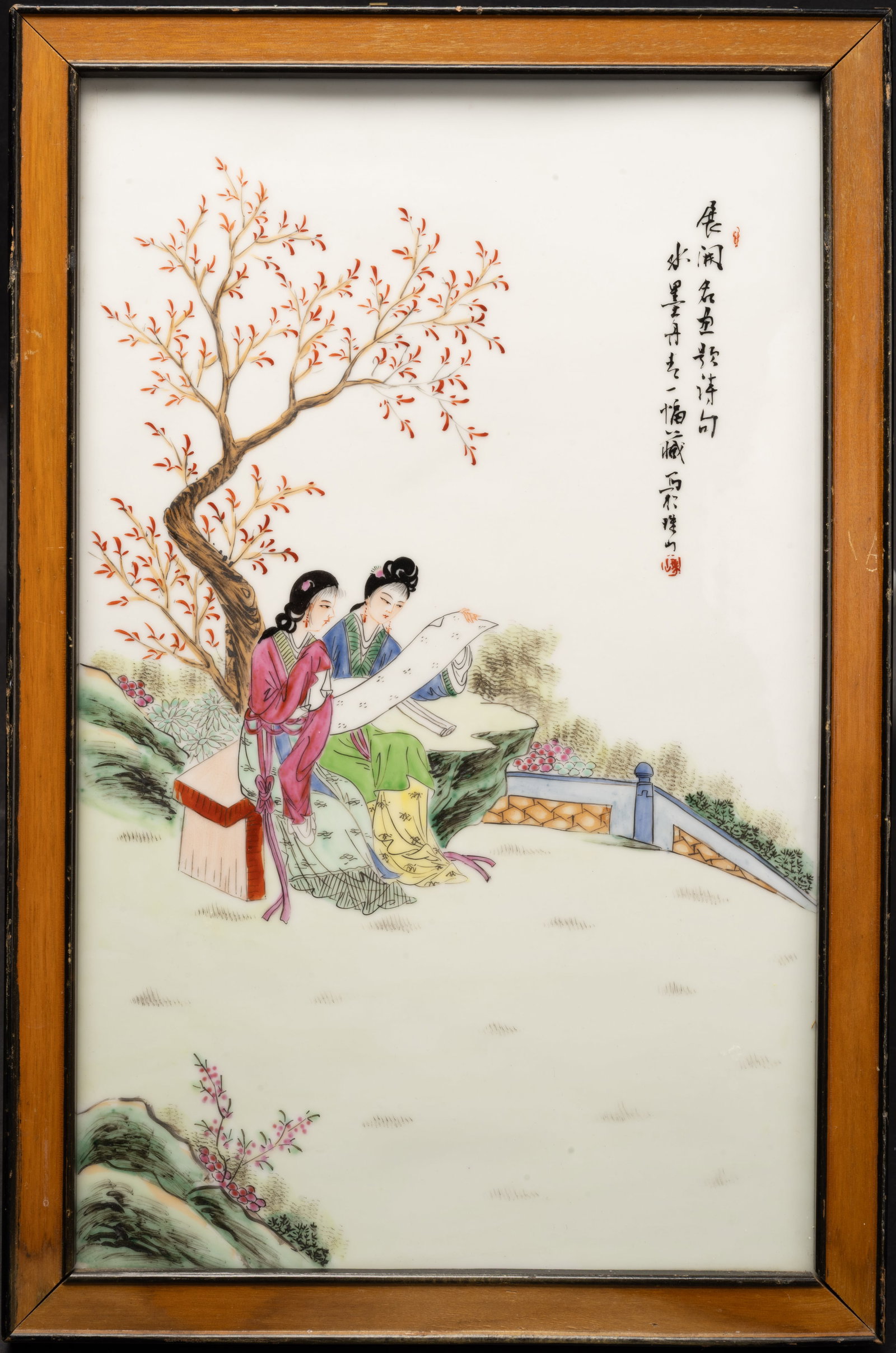 Chinese Famille Rose Porcelain Wall Panel: Chinese Famille Rose Porcelain Ceramic Wall Panel Depicting Two Elegant Ladies in Traditional Attire Figures in a Garden Setting Sitting on a Bench and Examining a Scroll Under Tree with Chinese