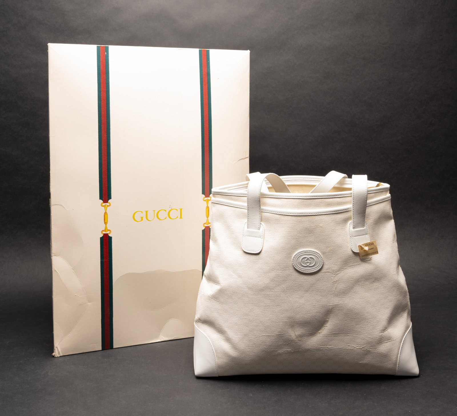 Gucci GG Monogram Tote Bag With White Leather Trim: Gucci Tote Bag in White Textured GG Monogram Fabric with White Leather Trim Dual Shoulder Straps Embossed Interlocking Logo Medallion Zip-Top Closure Gold-Tone Zipper Charm Interior Zip Pocket with Pl
