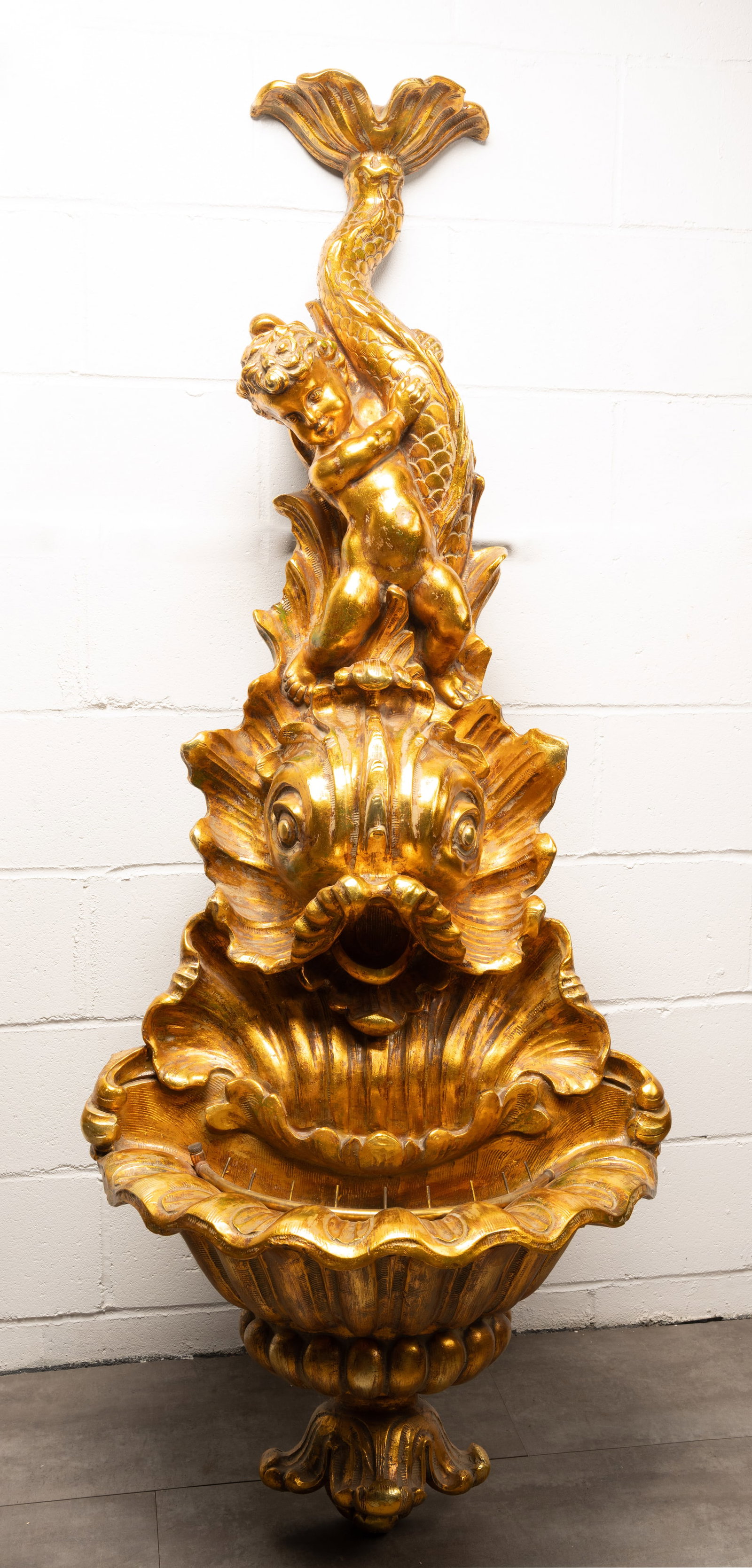 Italian Gilt Wall Fountain Rococo Style Dolphin & Cherub Motif: Italy Gilt Wall Fountain Rococo Style Dolphin and Cupid Motif Gilded Depicting a Cherub Putti Positioned Above a Dolphin with Basin at Bottom with Water Pump where Water Can Flow Popm is in Running
