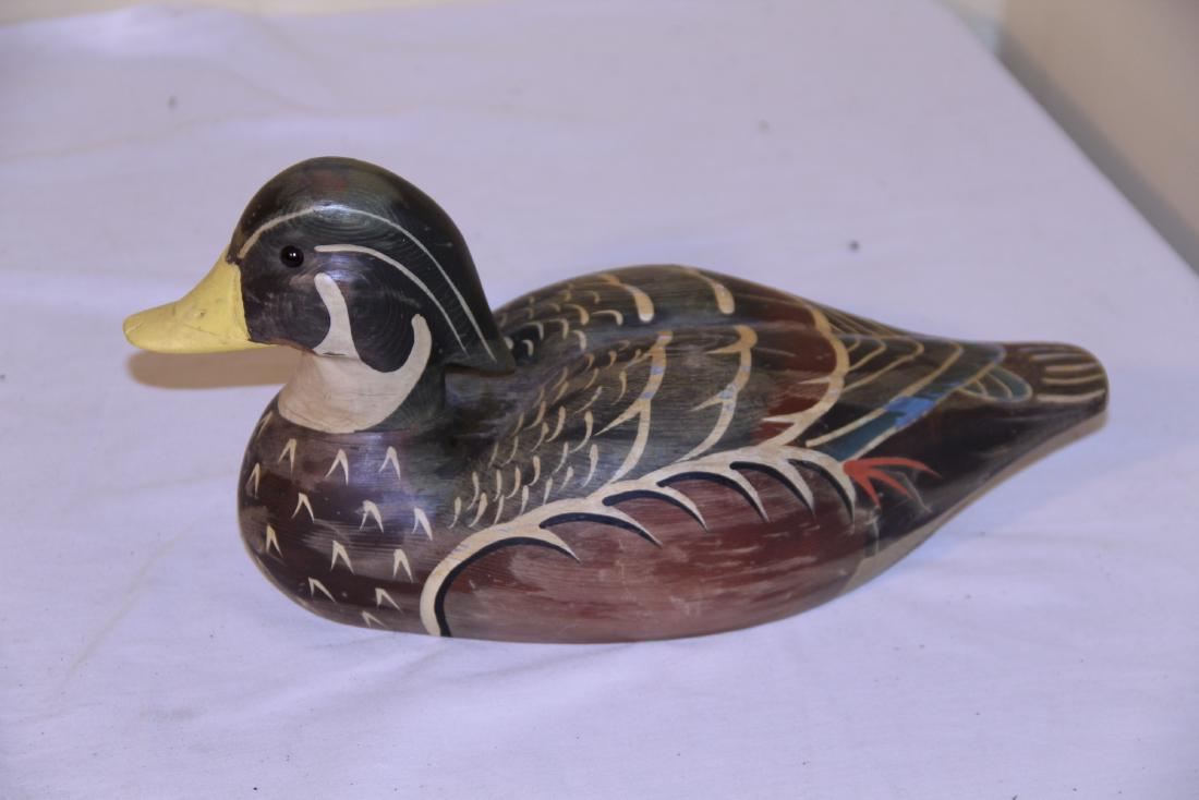 Signed wooden duck decoy: This beautiful multicolored bird measures 13” L and signed ZANE on bottom. The overall condition is great with no damage or repair. Has great paint and would add to any shop or home. See photos