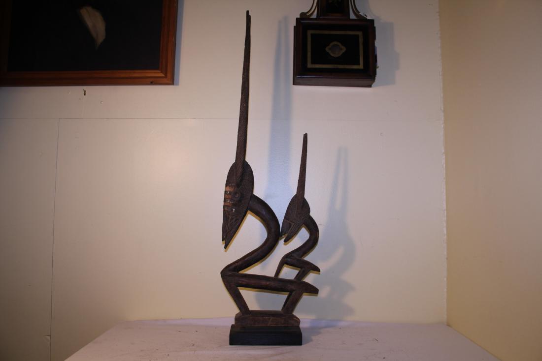 Large African carving: This large carving has two figures in it. The first 38 ½ â€œ and the second is 24” T. This metal on the faces and is beautifully carved. The base is newer then the carving. This appea