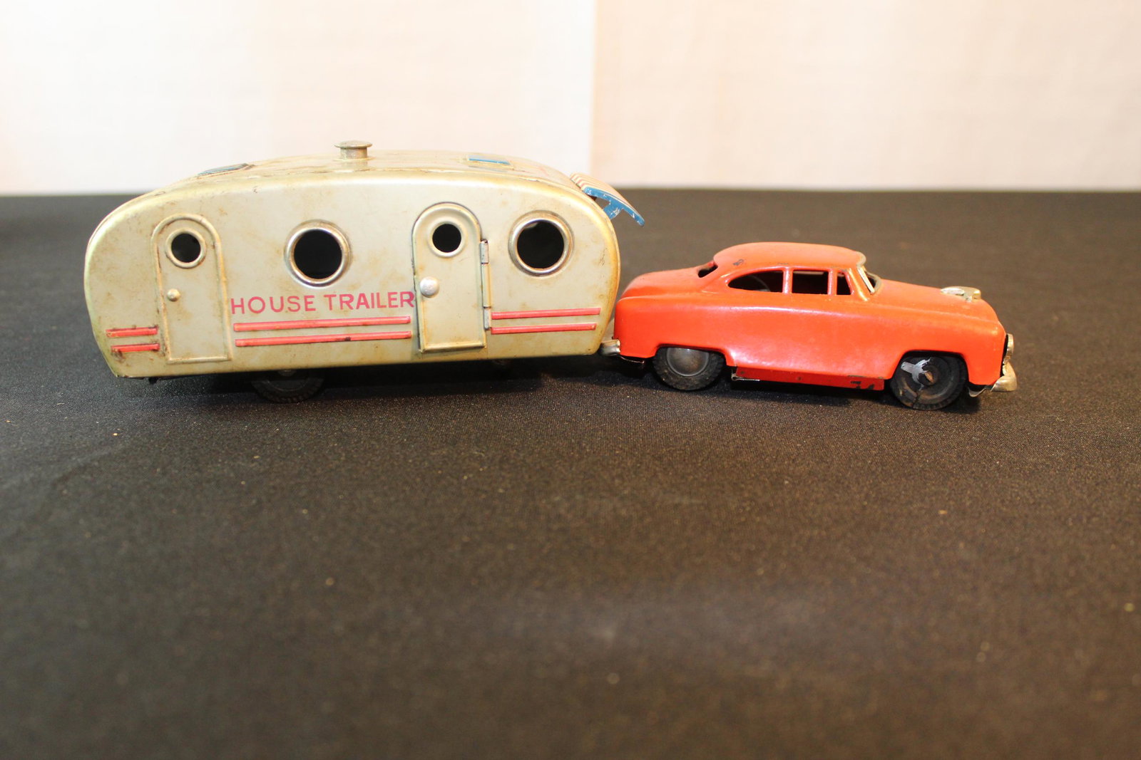 Antique tin car and camper toy: This nice toy is in great overall condition. This will clean up amazing. When not in use the car will store right inside the trailer. This vintage toy is missing just on small wheel cover off passenge