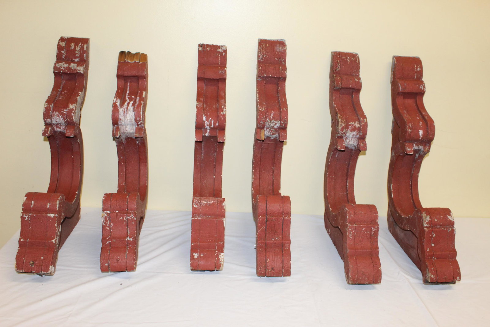 Lot of red painted corbels: This lot includes 6 corbels that measure 24in L x 16in D overall. These have red alligated paint and come off an early home. There are a few chips as you would expect however for the most part in grea
