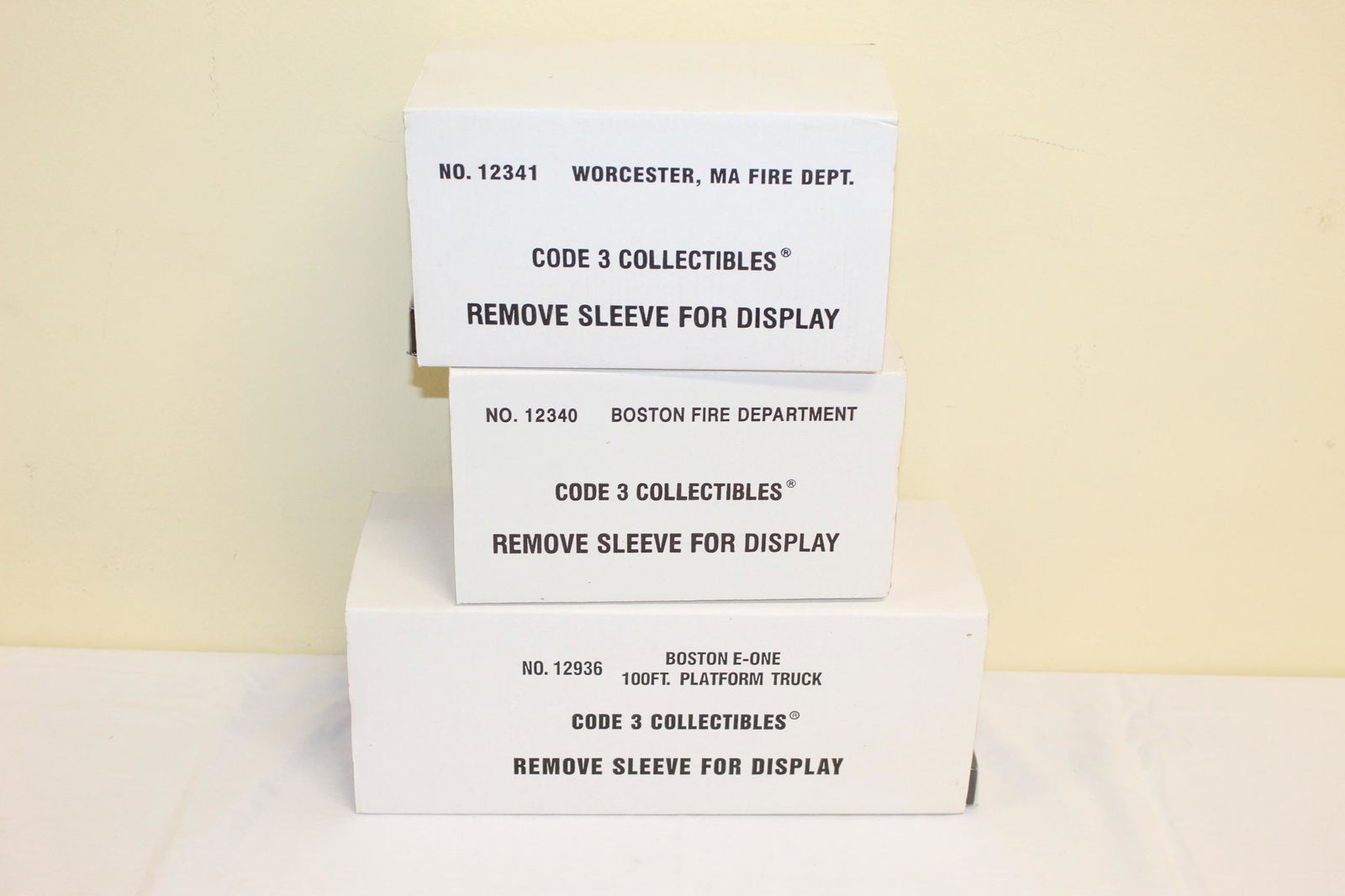 Lot of Code 3 Collectibles: This lot includes three code 3 collectibles, all in original boxes and packaging. Listed as follows; No. 12341 Worcester, MA Fire Dept. 1/64 scale. No. 12340 Boston Fire Dept. 1/64 scale. And lastly t