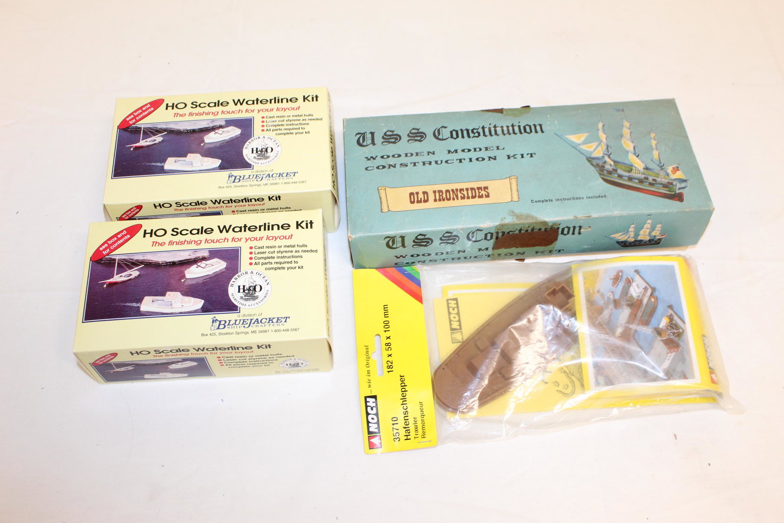 Lot of boat model kits: This lot includes; HO scale waterline kit, one is unopened and the other is opened however looks untouched- in original boxes. Noch 35710 Hafenschlepper trawler in original package and unopened. USS C