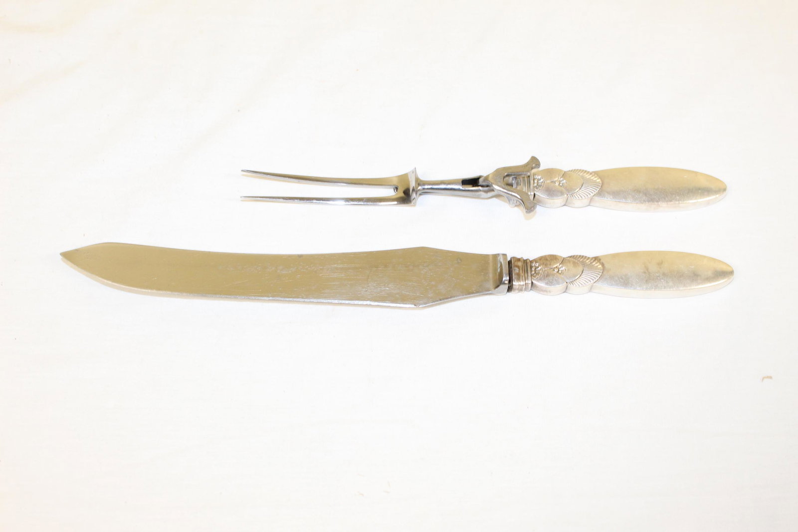 George Jensen sterling silver carving set: This beautiful set is marked sterling on the handles as well as has a GJ makers mark. Blades are marked stainless steel as well as knife blade is marked Frank Sheffield England. Knife measures 14in L 