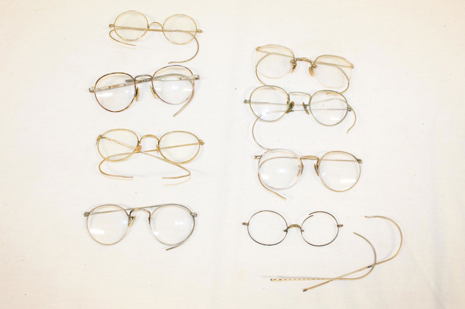 Lot of antique glasses: This lot includes 8 pairs of glasses. Measure around 5in L overall. Some rims are marked 12K GF. Pair of these glasses is missing the glass lenses and a few other pairs are loose in different areas. S