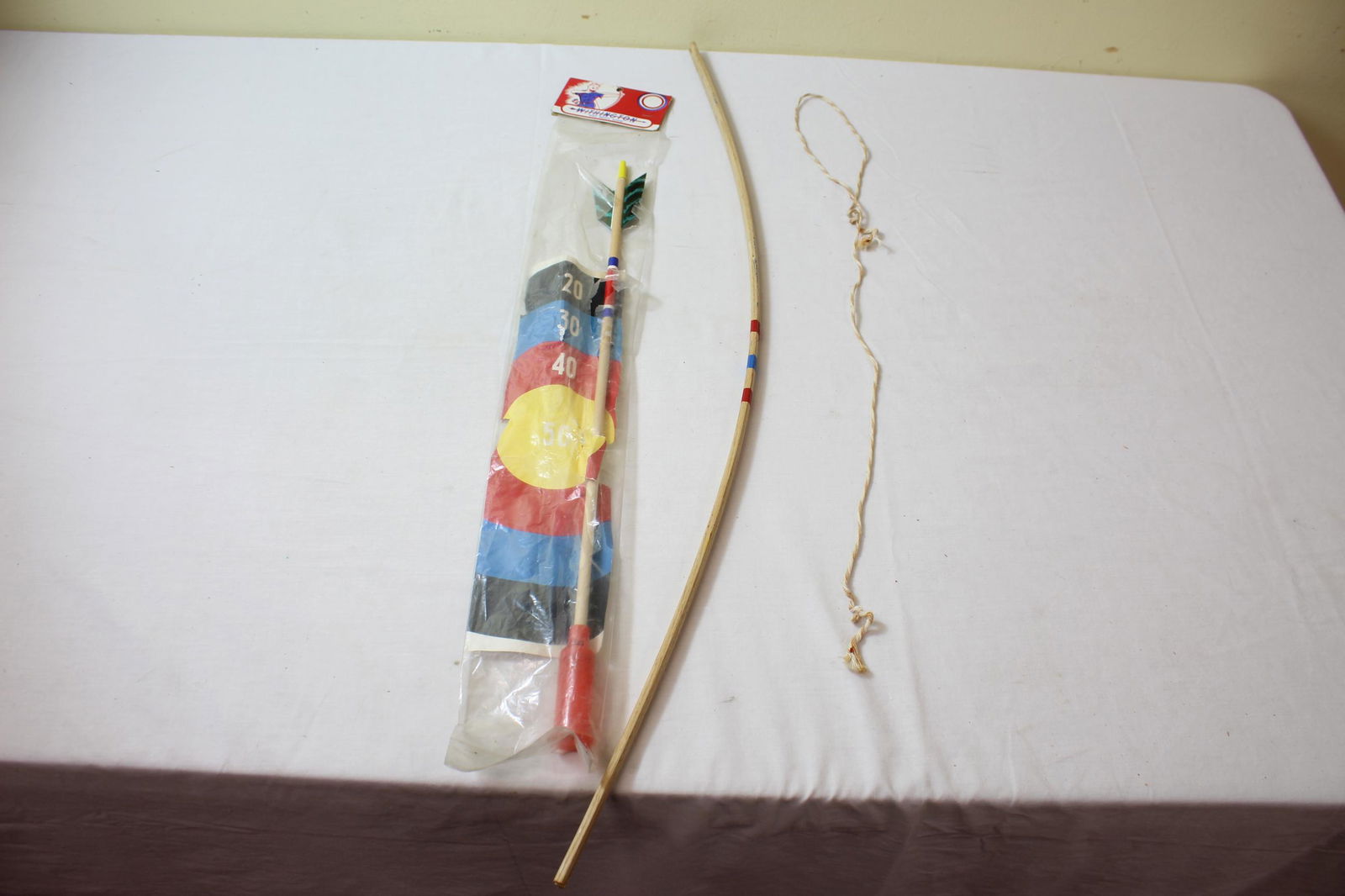 Withington West Minot, Maine bow and arrow set: This nice vintage set includes target, arrow and bow. Bow is broken, however it is a clean break. The target is a bit ripped. Arrow appears in good condition. Photos show exactly what your getting. Se