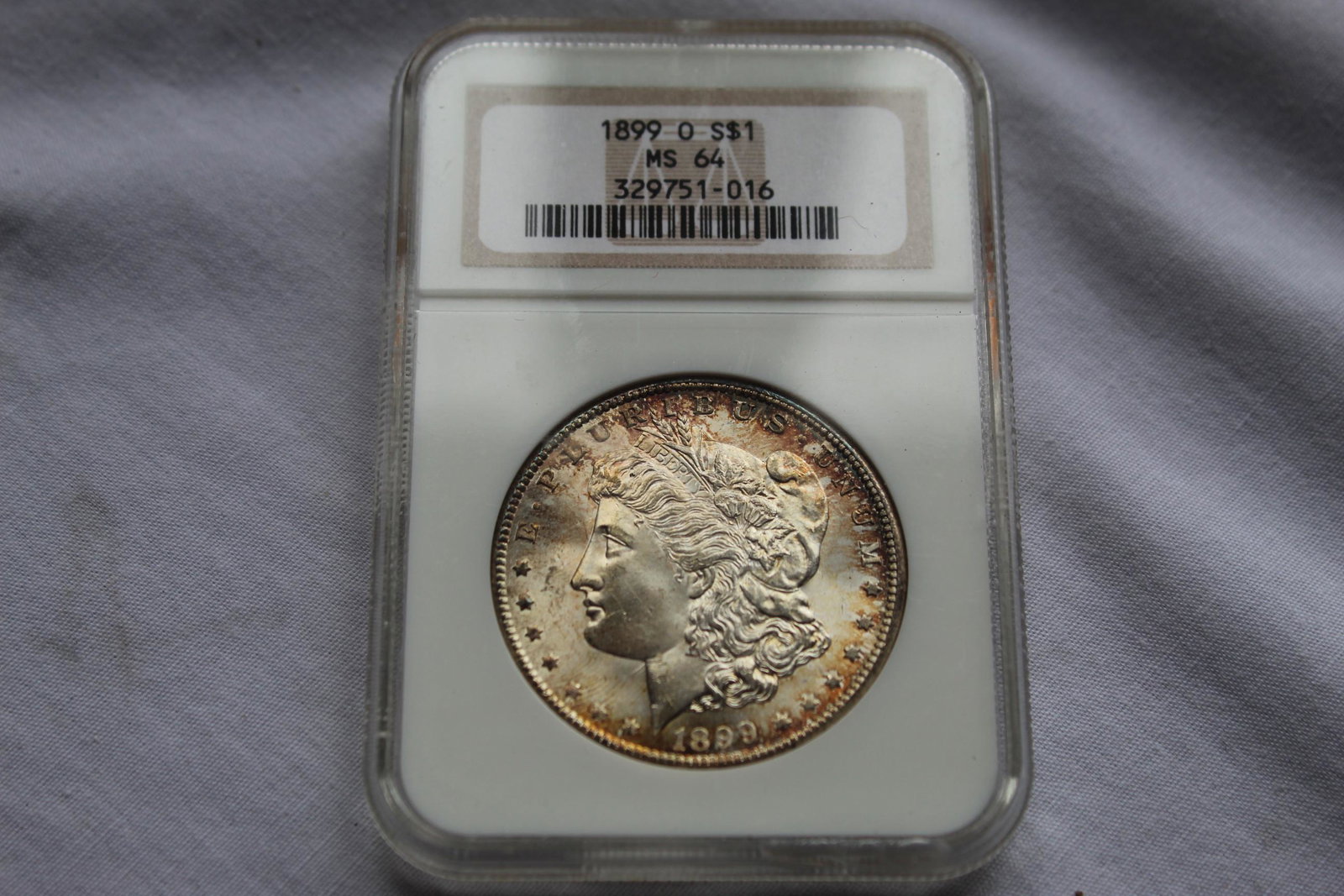 Graded 1899-O MS 64 Morgan Dollar: This 1899-O $1 Dollar Coin is graded by NGC as a 1899 0 S$1 MS 64. It is designed by George T Morgan and is composed of silver 0.9000 measuring 38.1mm in diameter. As always please see all photos and 
