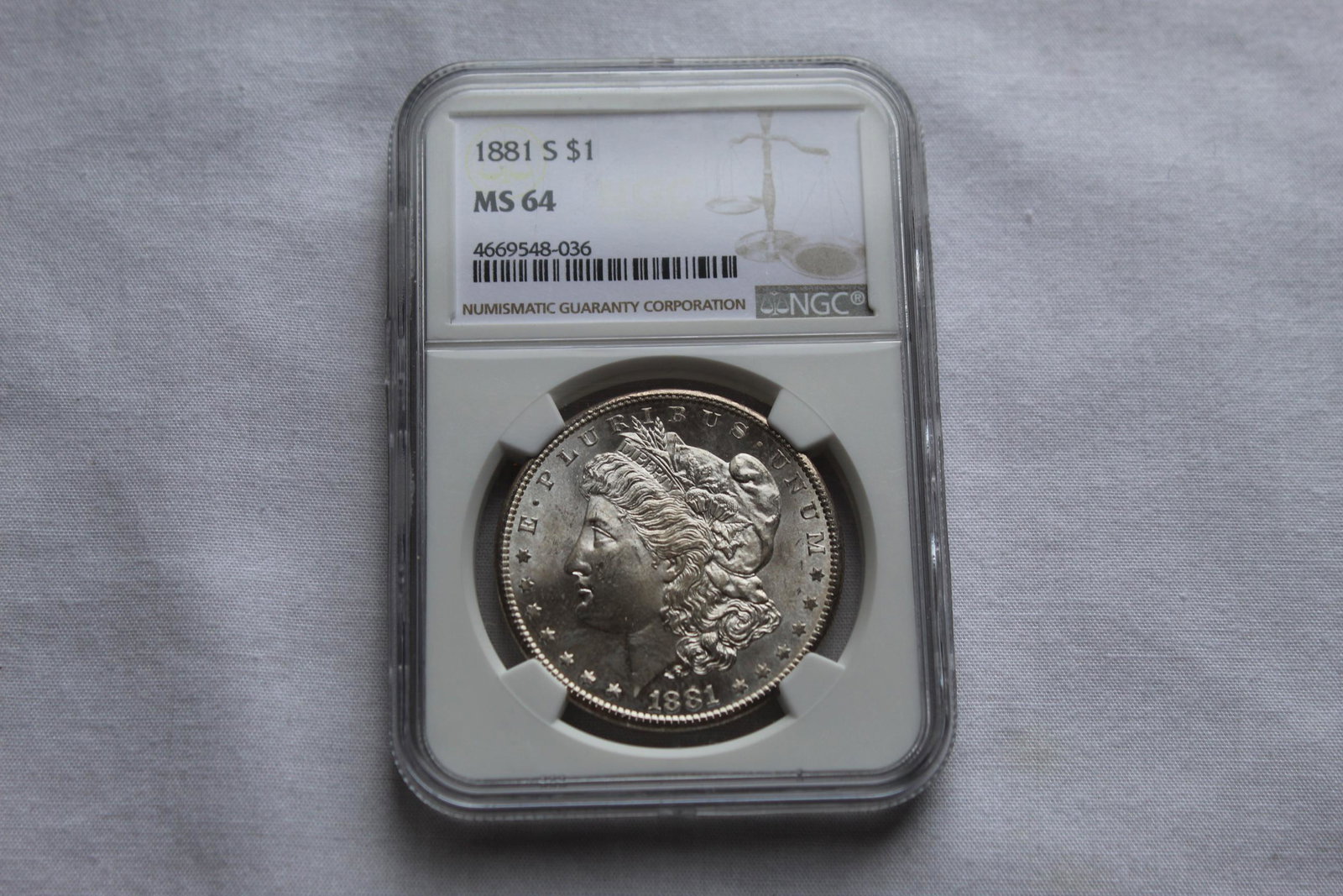 Graded 1881-S MS 64 Morgan Dollar: This 1881-S $1 Dollar Coin is graded by NGC as 1881 S MS 64 Morgan $1 Coin. It is designed by George T Morgan and is composed of silver 0.9000 measuring 38.1mm in diameter and weighing 26.7300g. As al