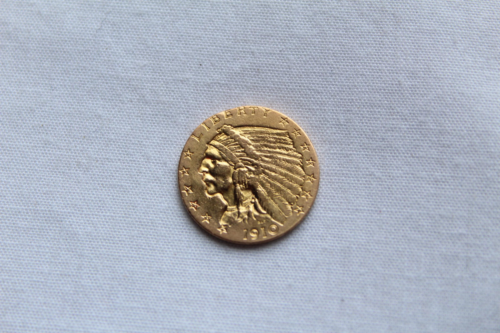 1910 $2.50 Indian Head Coin: This 1910 Indian Head Two and a Half Dollar Coin was designed by Bela Lyon Pratt, minted in Philadelphia along with 492,000 others that year. It is composed of gold 0.9000 measuring 18mm in diameter a