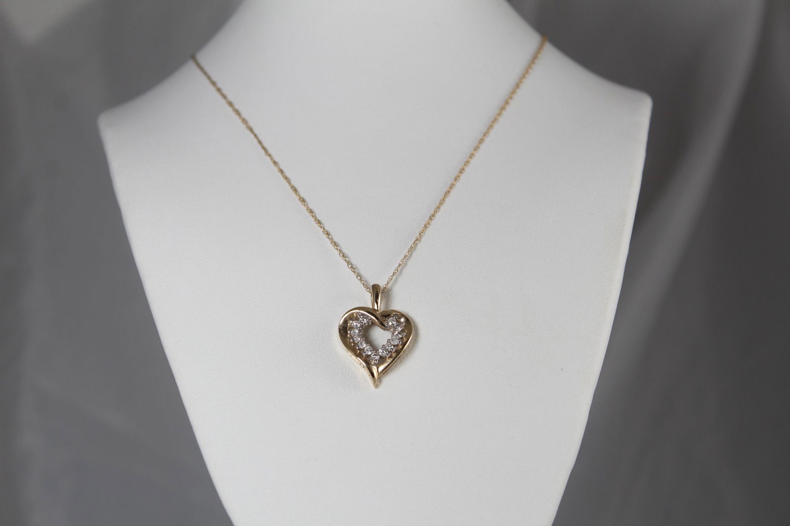 2.6 Gram 10K Gold Necklace with Diamond Heart pendant: This beautiful 19 inch long necklace features a heart shaped pendant with 13 small diamonds all along the inside. I do not see a marking on the pendant itself but it is marked SUN 10K on the clasp. Th