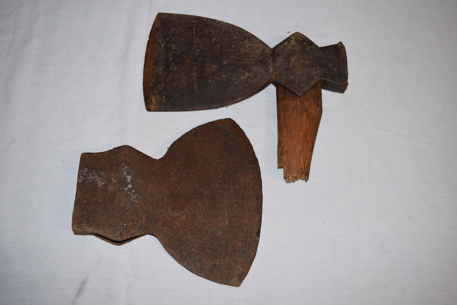 Pair of Broad Axe Heads: This nice pair of broad axe heads are in great overall condition. The wider head measures 8.5in W x 9in L overall. The second head in this lot measures 6in W x 11in L overall. This head still has a sm