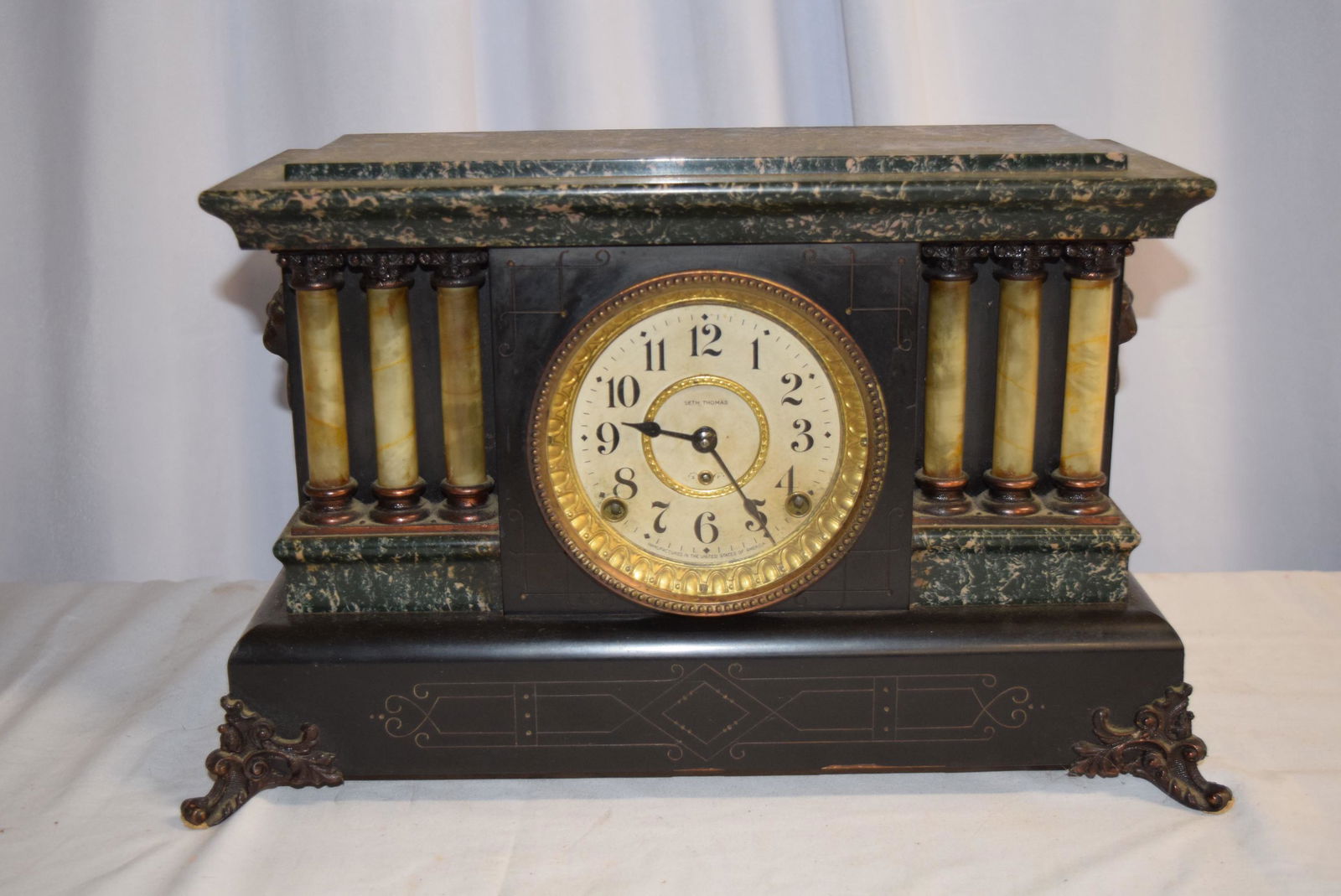 Antique Seth Thomas Mantle Clock: This beautiful mantle clock measures 16in W x 6.25in D x 10.25in T overall. Has lion head handles on each side. The marble looking pillars on one side are a little loose otherwise I see no damage or r