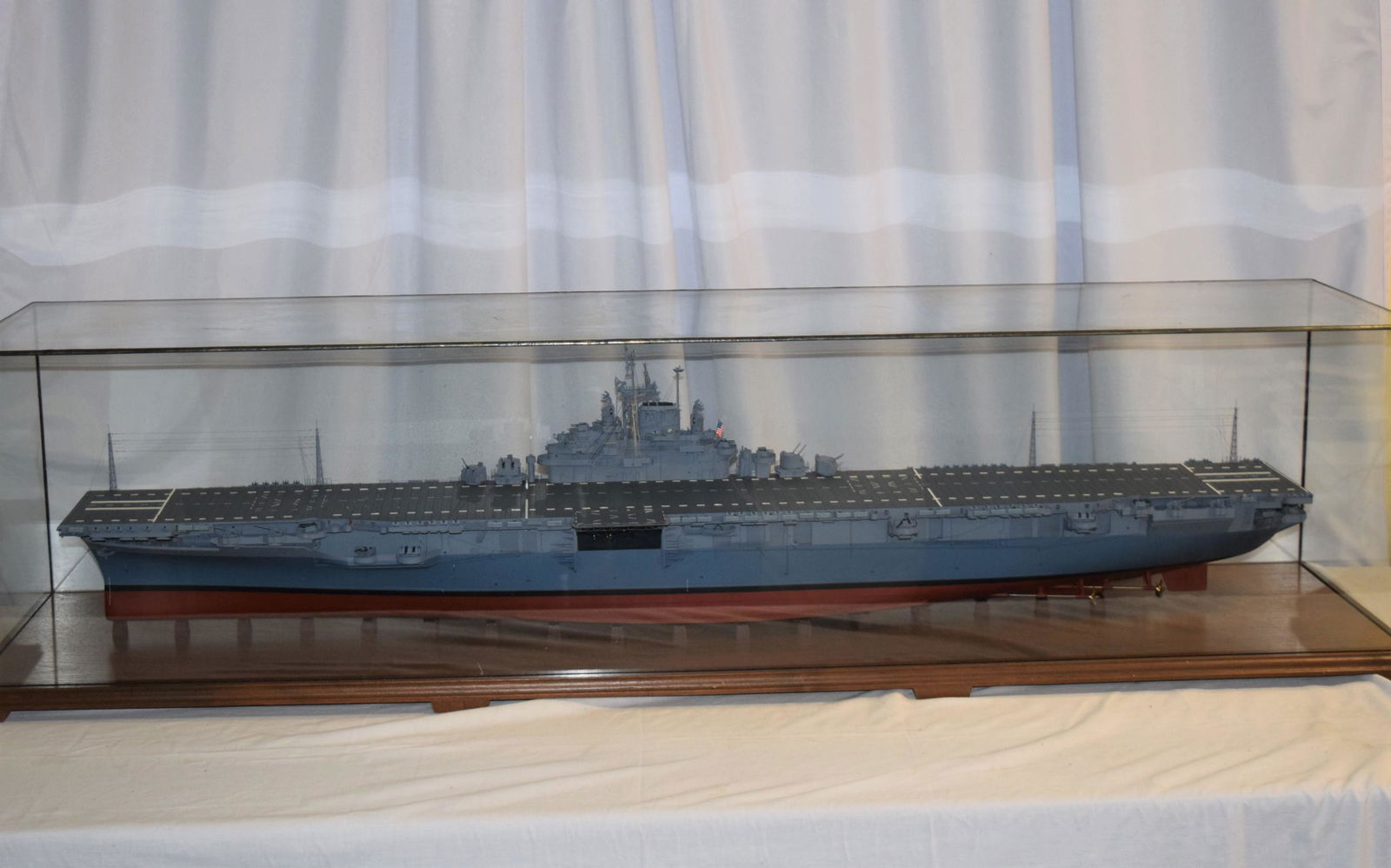 Very Navy Ship Model In Case: Very Large Navy Ship Model In Case With Case in great condition. Comes with several small planes and helicopters as pictured to put on the Naval Ship. The case measures 15.75 inches wide X 62 inches l