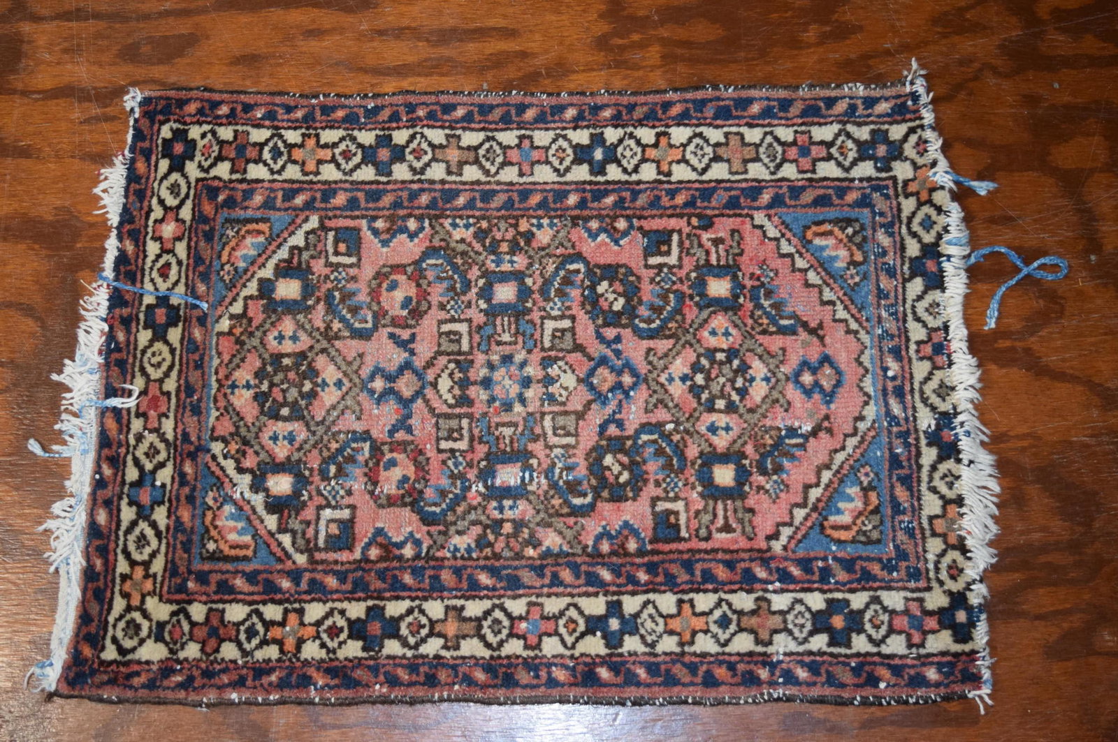 Small Oriental Area Rug: Nice Small Oriental Area Rug with muted colors of blue, pale pink, and orange; measuring 31inches long 22.5 inches wide. There is some string missing from the ends but otherwise appears to be in great
