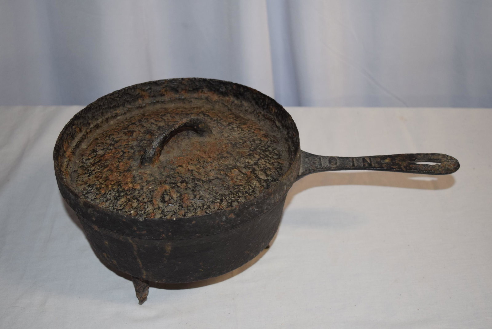 Cast Iron Kettle With Cover: Turn of The Century Cast Iron Kettle With Cover, Has Three Feet, Embossed 10 IN on handle, measuring 6.5 inches tall X 17 inches wide including handle. As always please see all photos and ask any ques