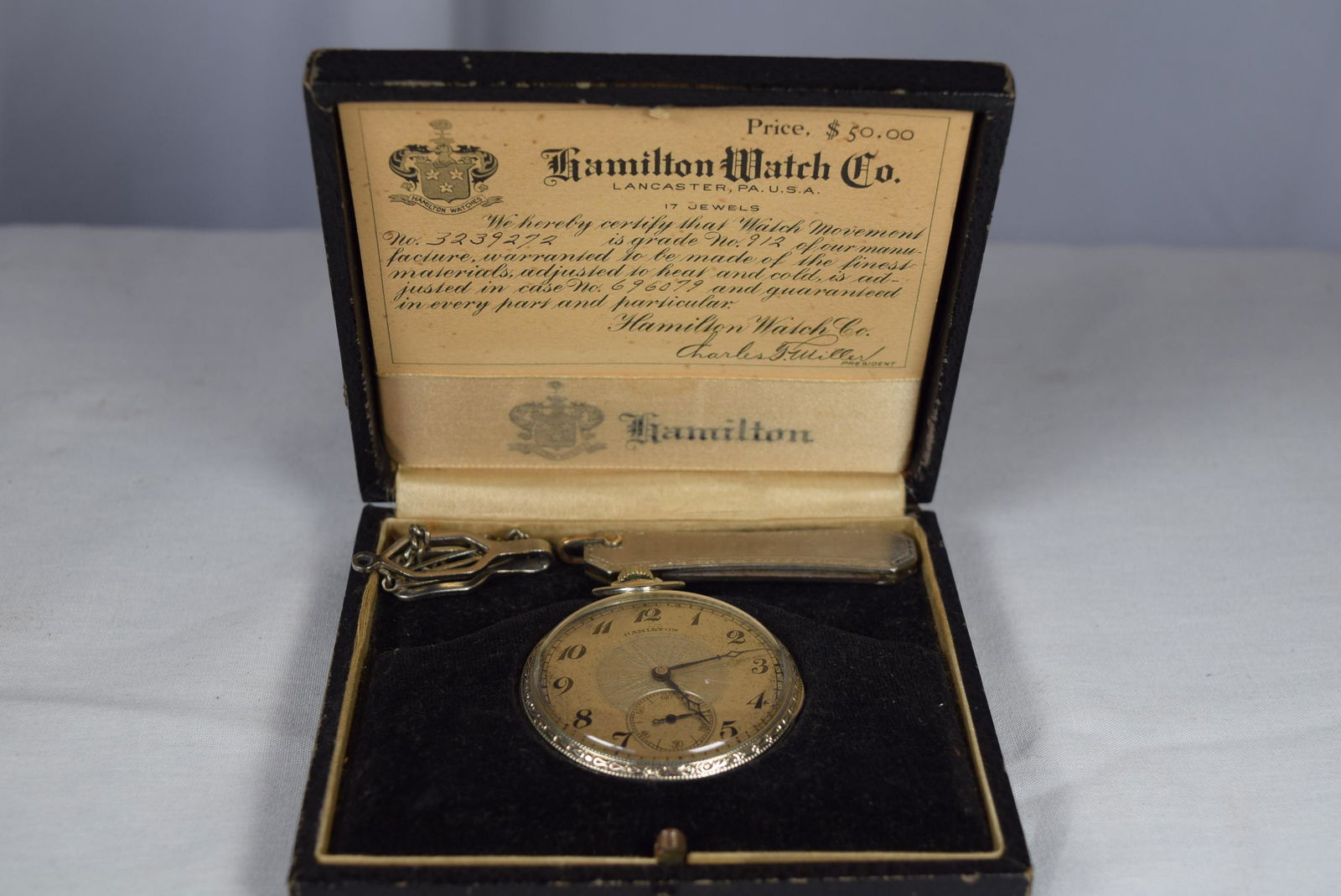 Hamilton Watch Co. Pocket Watch in Case: This beautiful pocket watch is marked Hamilton Watch Co. Lancaster PA. Serial Number: 696079. Also marked 14K gold filled 696079. The works are marked Hamilton Watch Co. Lancaster PA, 17 Jewels Adjust