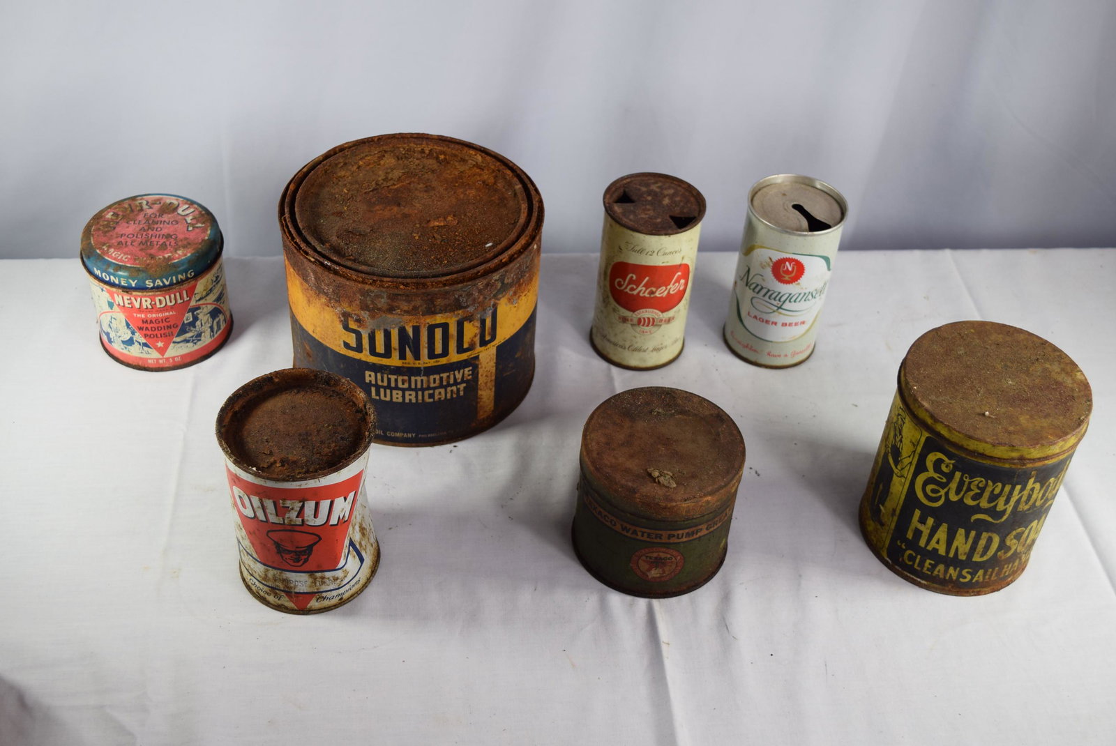 Vintage AD Tins Lot: This lot includes 7 vintage AD tins. These are advertising as follows; Schaefer Americas Oldest Lager Beer Established 1842 - 12oz can. Narragansett Lager Beer - 12oz can. Nevr-Dull Magic Wadding Poli