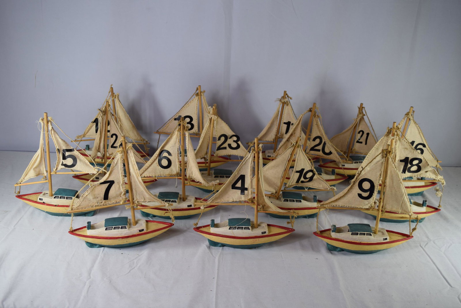 Reproduction Pond Boats Lot: This lot includes approx. 15 boats. These measure 10.5in L x 3.5in W x 11.5in T overall. These are nicely painted and in great overall condition. A sail is loose and needs to be tightened on a few how