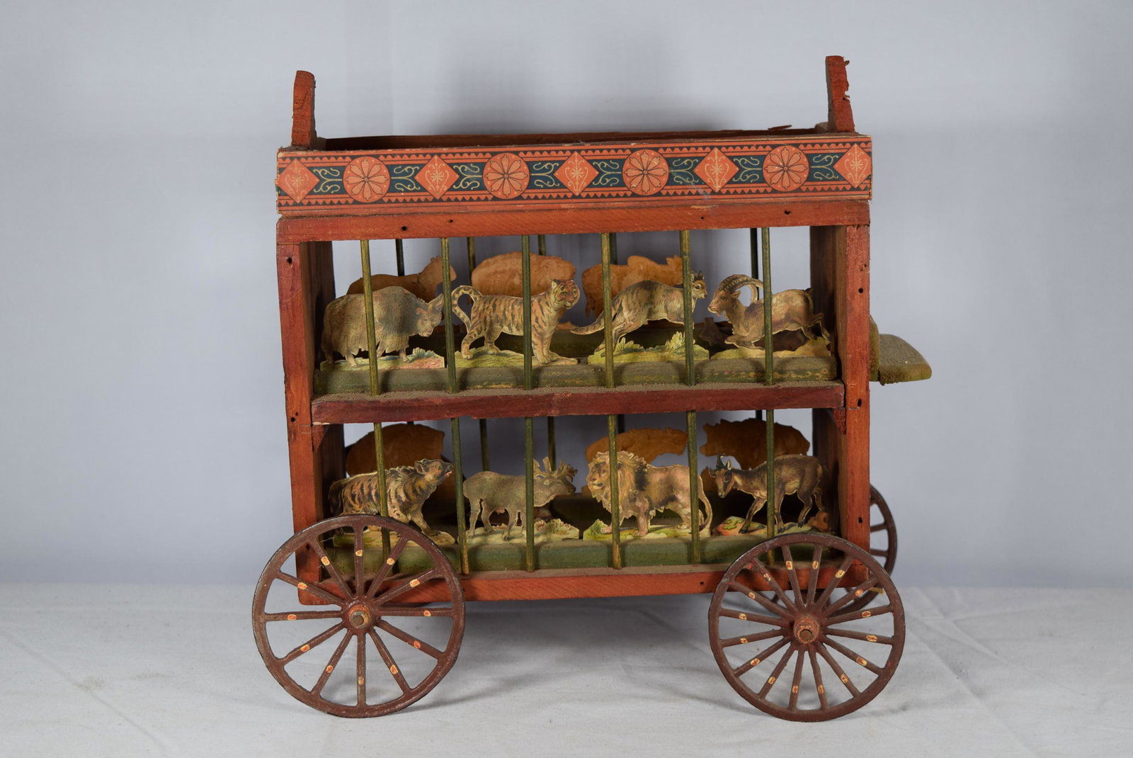 Vintage Wooden and Cast Iron Circus Wagon: This nice early toy features different animals on the top and bottom cages of the wagon. There are beautiful graphics attached to either end of young girl. The cast iron wheels are hand painted. Two o