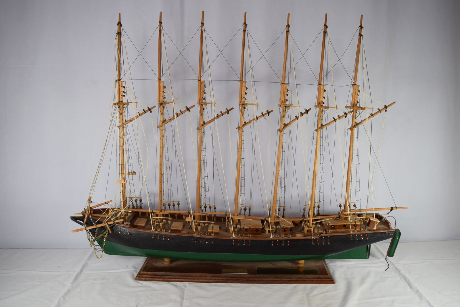 Large Wooden Boat Model On Stand: This beautiful wooden boat model includes plaque on the base of the stand that reads Thomas W. Lawson as well as a dedication plaque on the side of that for the person that this boat was gifted to at