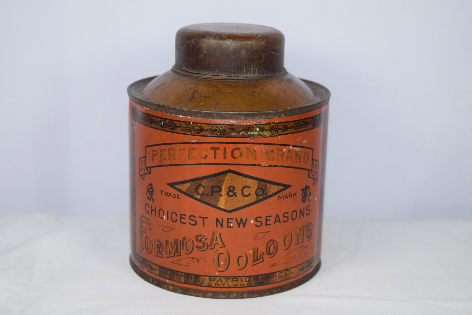 Vintage Conant Patrick & CO. Portland ME AD Tin Can: This vintage advertising tin is a bit smaller then the previous tin and measures approx. 5in T x 4.25in R on base. This tin reads Perfection Brand C. P. & Co. trade mark Choicest New Seasons Formosa O