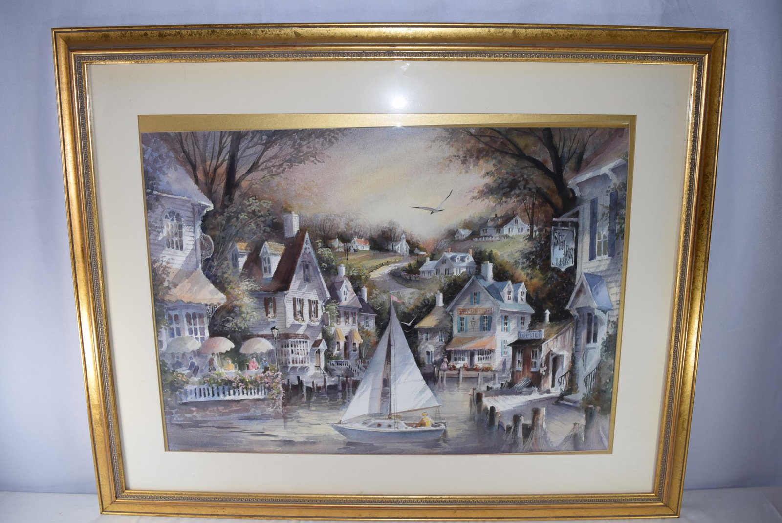 Large George Bjorkland Watercolor Framed: Large George Bjorkland Watercolor Framed: depicts a harbor scene featuring the Harbor CafÃ© and the Ships Inn among other shops with vibrant colors throughout. Frame measures 39.75 inches X 31.5 inc