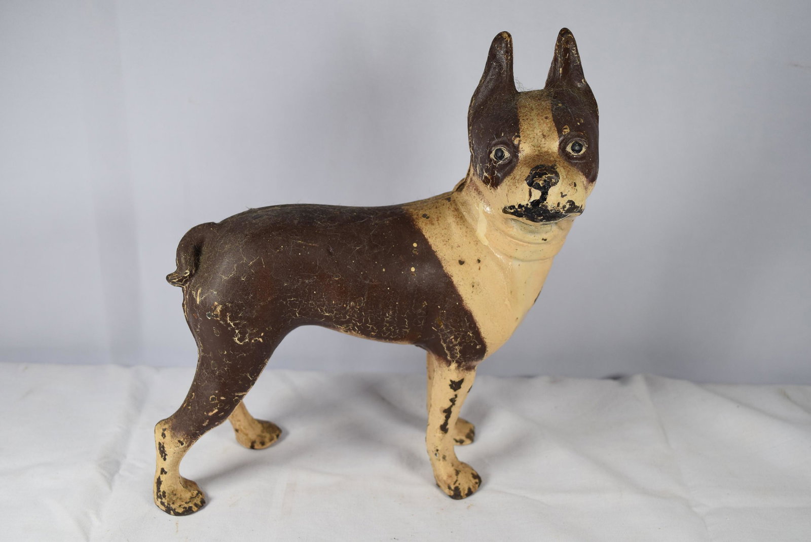 Antique Cast Iron Boston Terrier Door Stop: Antique Cast Iron Boston Terrier Door Stop: features: crÃ¨me, brown and black paint; Measuring about 8 inches long X 3 inches wide X 8.75 inches tall. Does have some flaking and chipping mostly alon