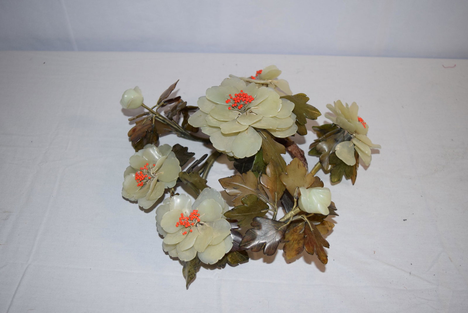 Jade and Jadeite Flowers: This beautiful flower display features jade flower petals with jadeite leaves. The branches are wrapped in silk thread. Small read beads in the center of the flowers. This piece is in amazing overall 
