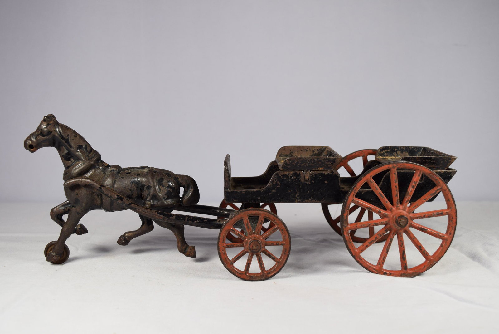 Vintage Cast Iron Horse Drawn Wagon Toy: This nice early cast iron toy measures approx. 12in L x 3.75in W x 4.5in T at tallest point which is horses head. overall. The seats are embossed Trilby, no other markings seen. This has red painted w